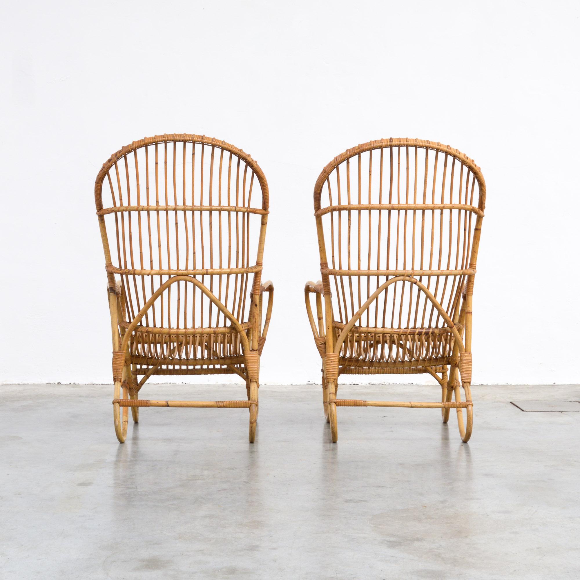 These elegant rattan armchairs can be dated in the 1950s.
It is a Dutch design from F. Paulussen, made by Schutting in the Frisian town of Noordwolde, known for its rattan production in the 1940s and 1950s.
Rattan was a popular material, used