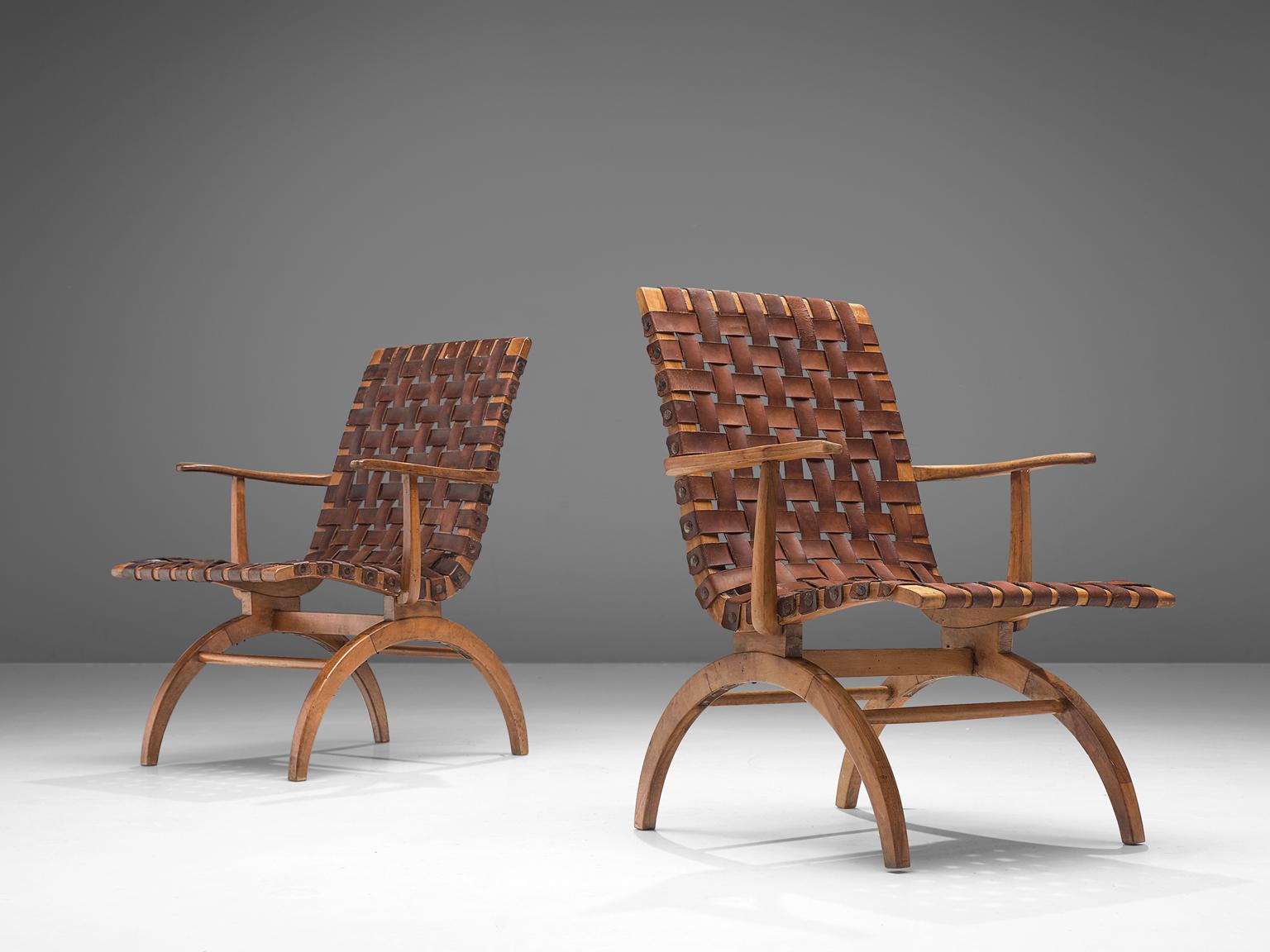Pair of Spanish armchairs, elmwood and patinated leather, Spain, 1960s

A pair of Spanish midcentury leather strap armchairs in patinated cognac leather with woven seats. The wonderfully carved wood bases are slim and elegant, which reminds of the