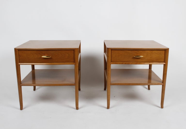 Pair of elegant and not often seen T. H. Robsjohn Gibbings nightstands for Widdicomb, dated 1955, label, walnut with original finish on splayed legs drawers having 22-carat gold porcelain handles. Light wear to gold, on tips of knobs. Light