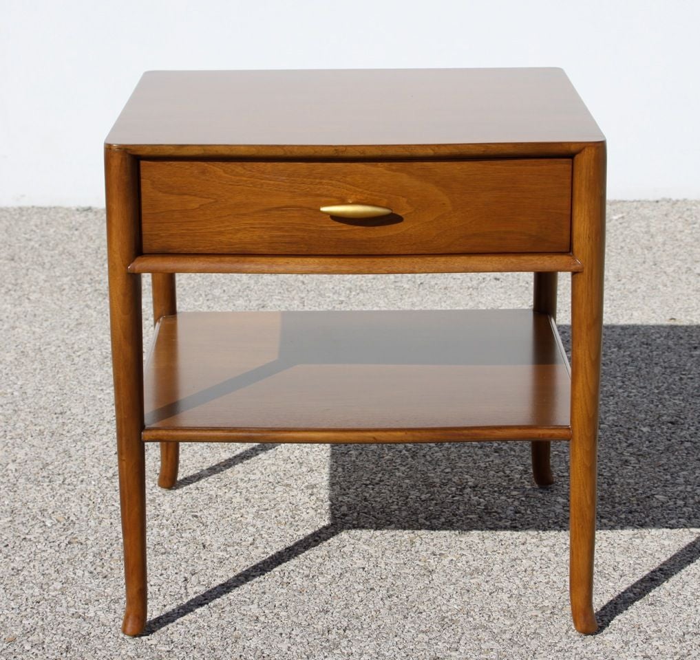 Pair of elegant and not often seen T. H. Robsjohn Gibbings nightstands for Widdicomb, dated 1955, label, walnut with restored original finish on splayed legs drawers having 24-karat gold porcelain handles. Tops always had glass, glass tops included,