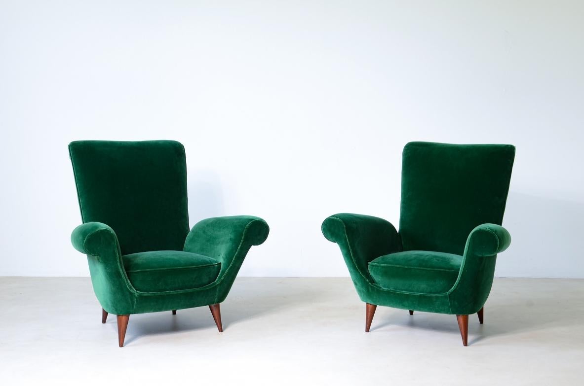 Pair of elegant upholstered velvet high back armchairs.

Italian manufacture around 1950.