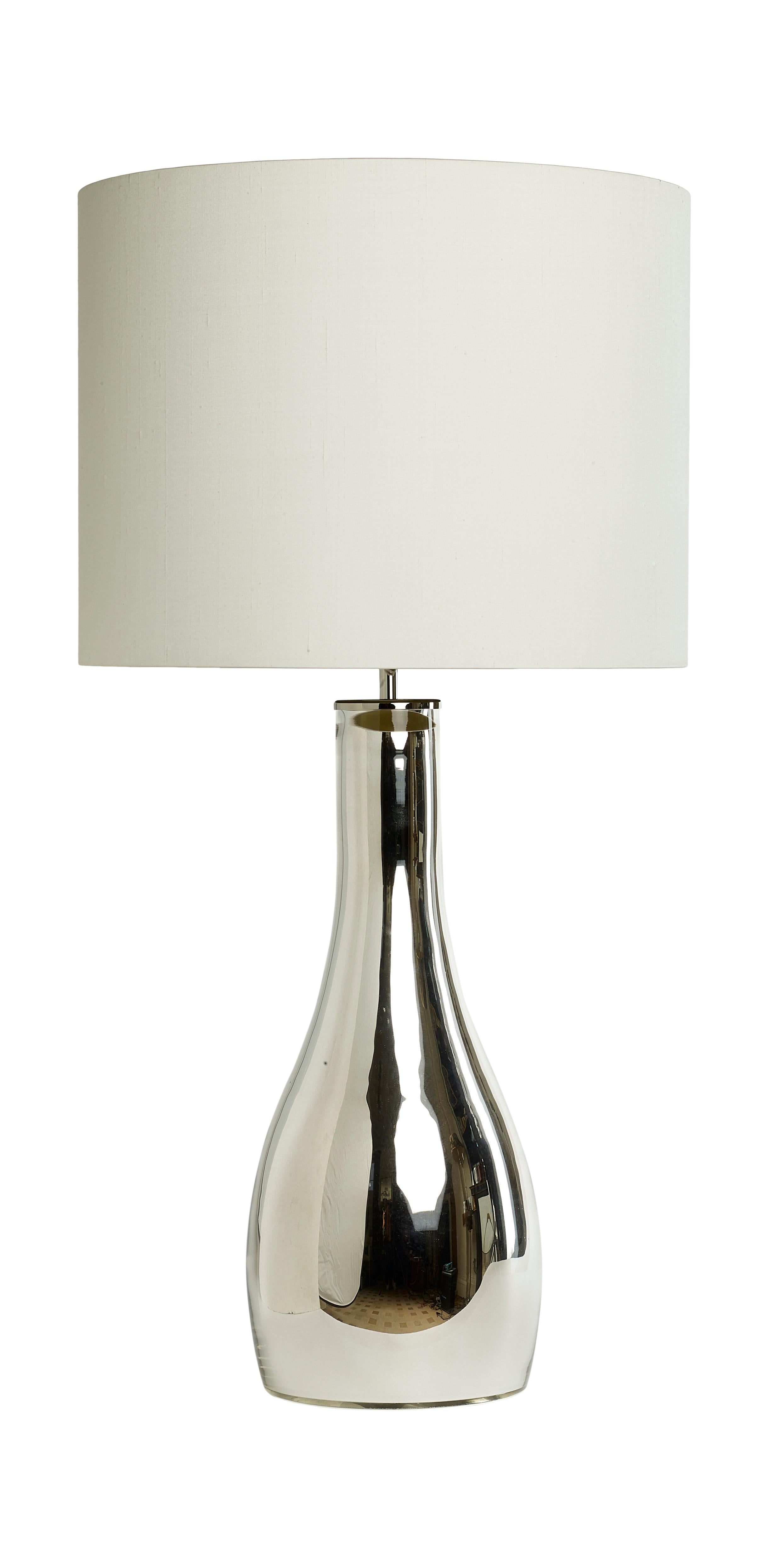 This is a pair of elegant modern Mirror Glass vase shaped Table lamps by Andrew Kornat Designs made by hand to exacting standards

Made of very fine clear glass and mirrored on the inside of the lamp with a thin metal plate at the base for stability