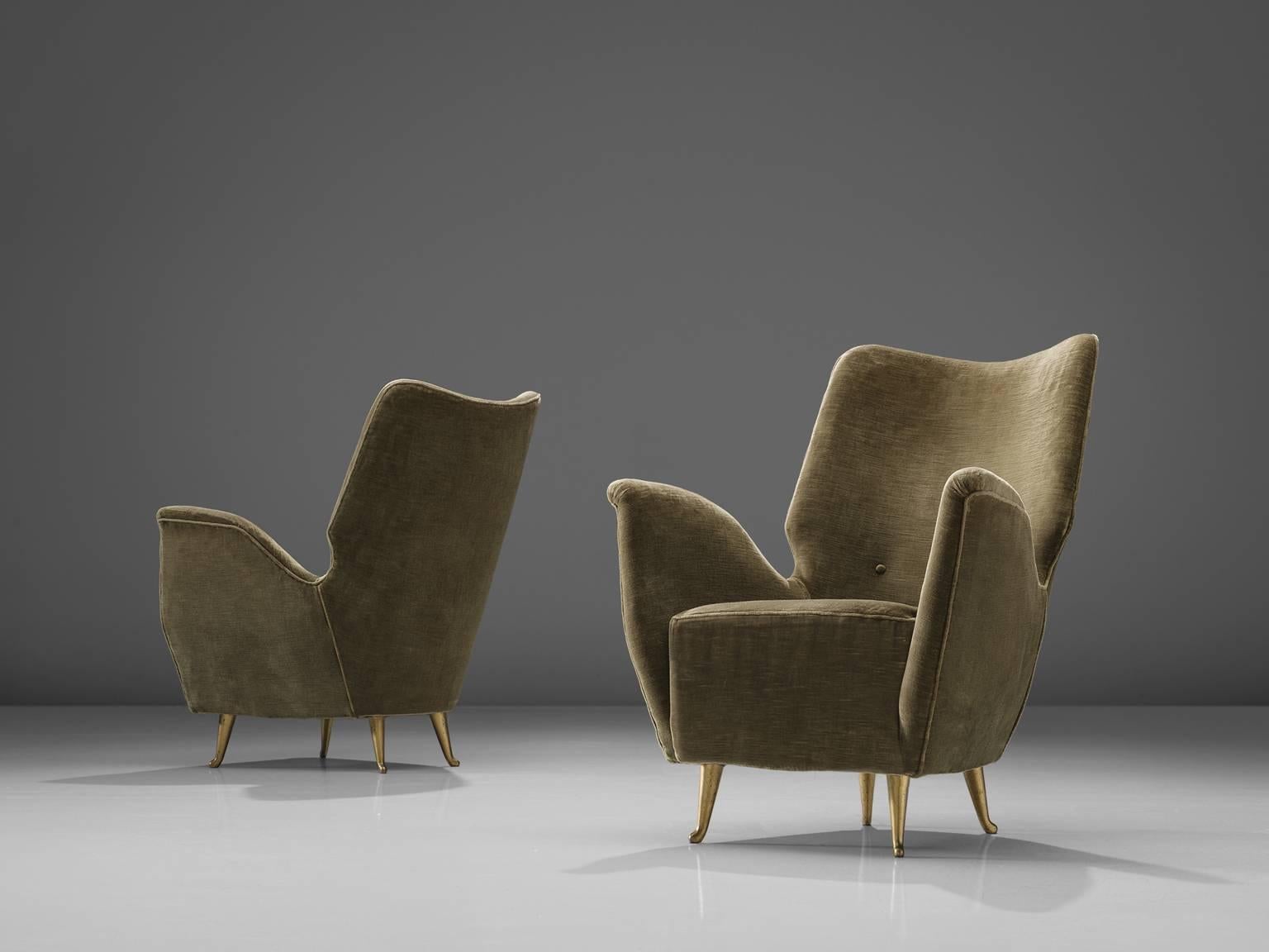 Lounge chairs by ISA, green velvet, brassed metal legs, Italy, circa 1950.

This pair lounge chairs is designed in 1950 in Italy. They stand out thanks to their butterfly armrests and high backs. Their size is wonderfully eloquent thanks to the
