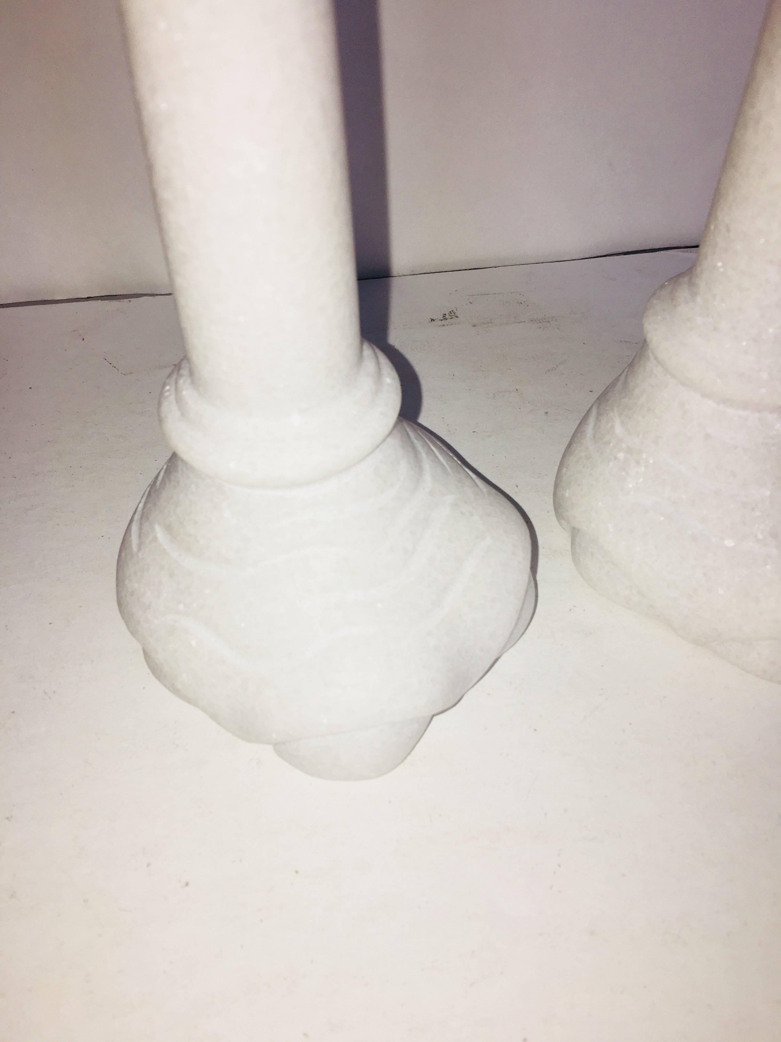 Pair of carved marble elephant feet candleholders.