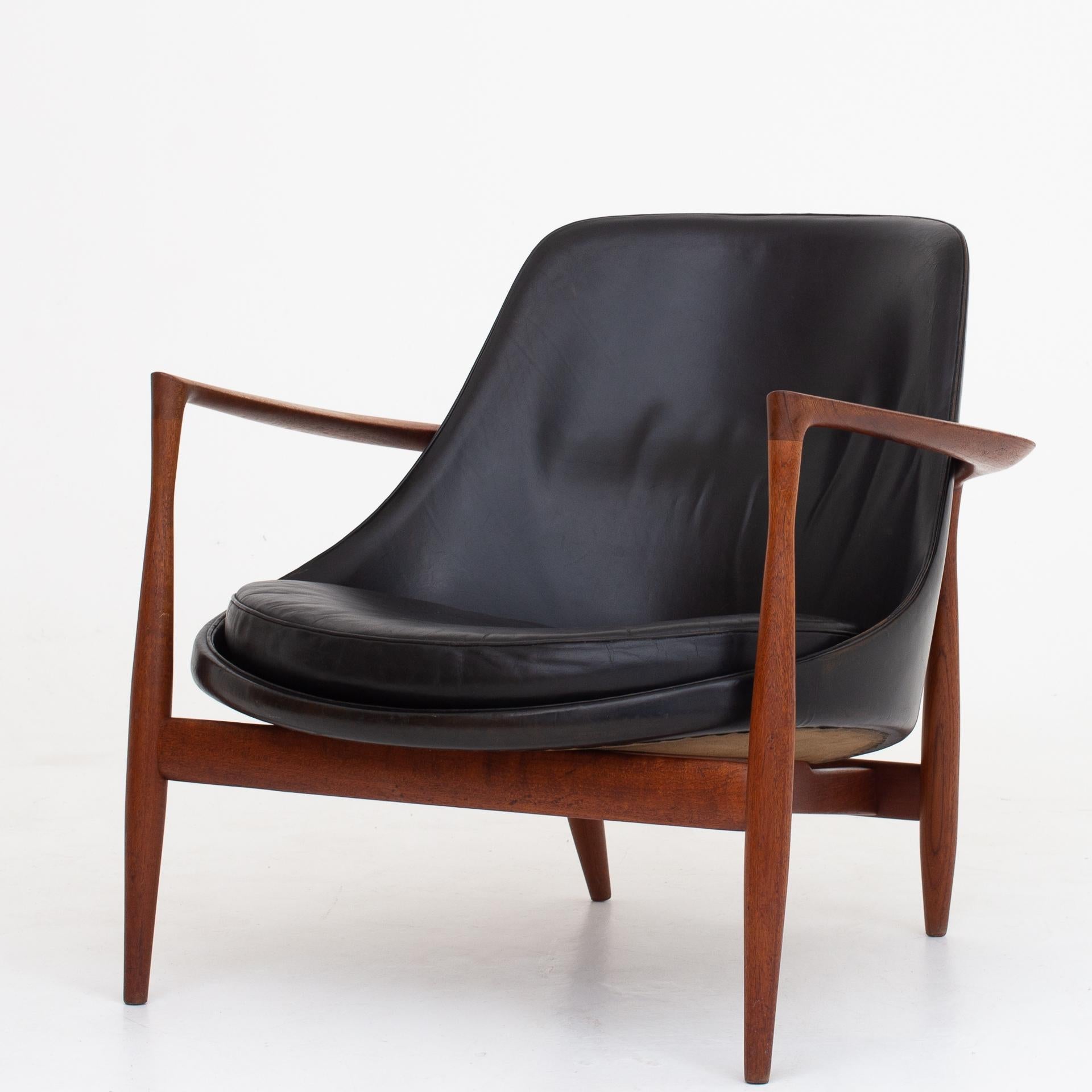 U56, pair of 'Elizabeth' easy chairs in teak and patinated black leather. Designed in 1956. Marked by maker Christensen & Larsen.