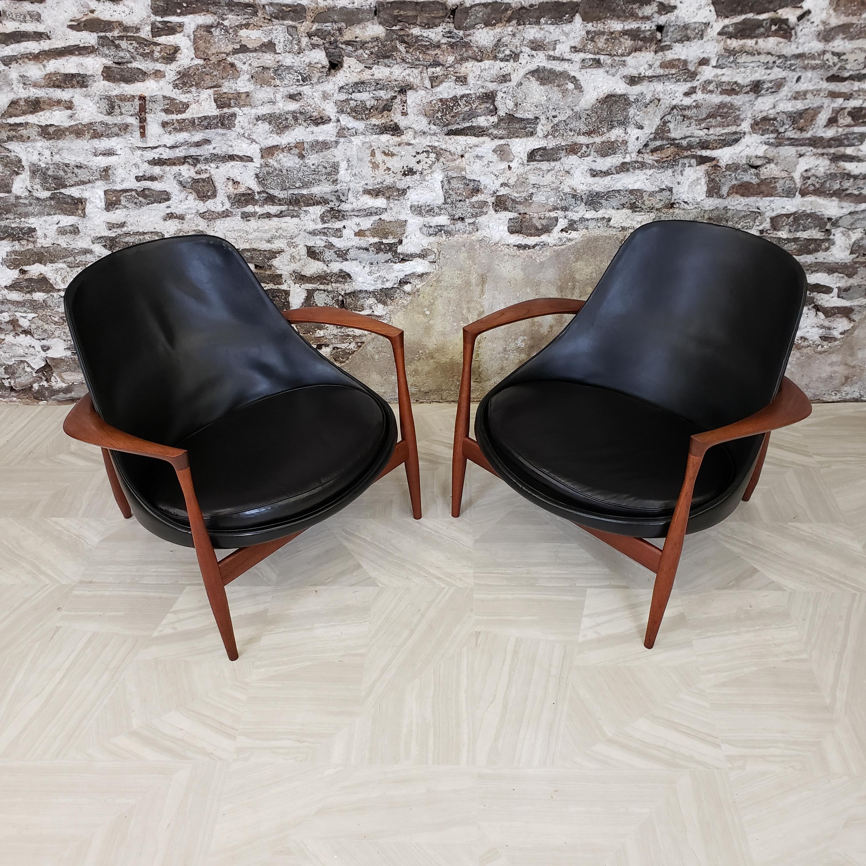 Pair of iconic teak and leather 'Elizabeth Chairs' by Ib Kofod-Larsen. These incredibly rare and exquisitely crafted Model U-56 chairs were designed in 1956 and later nicknamed the Elizabeth chair after Queen Elizabeth purchased a pair during a