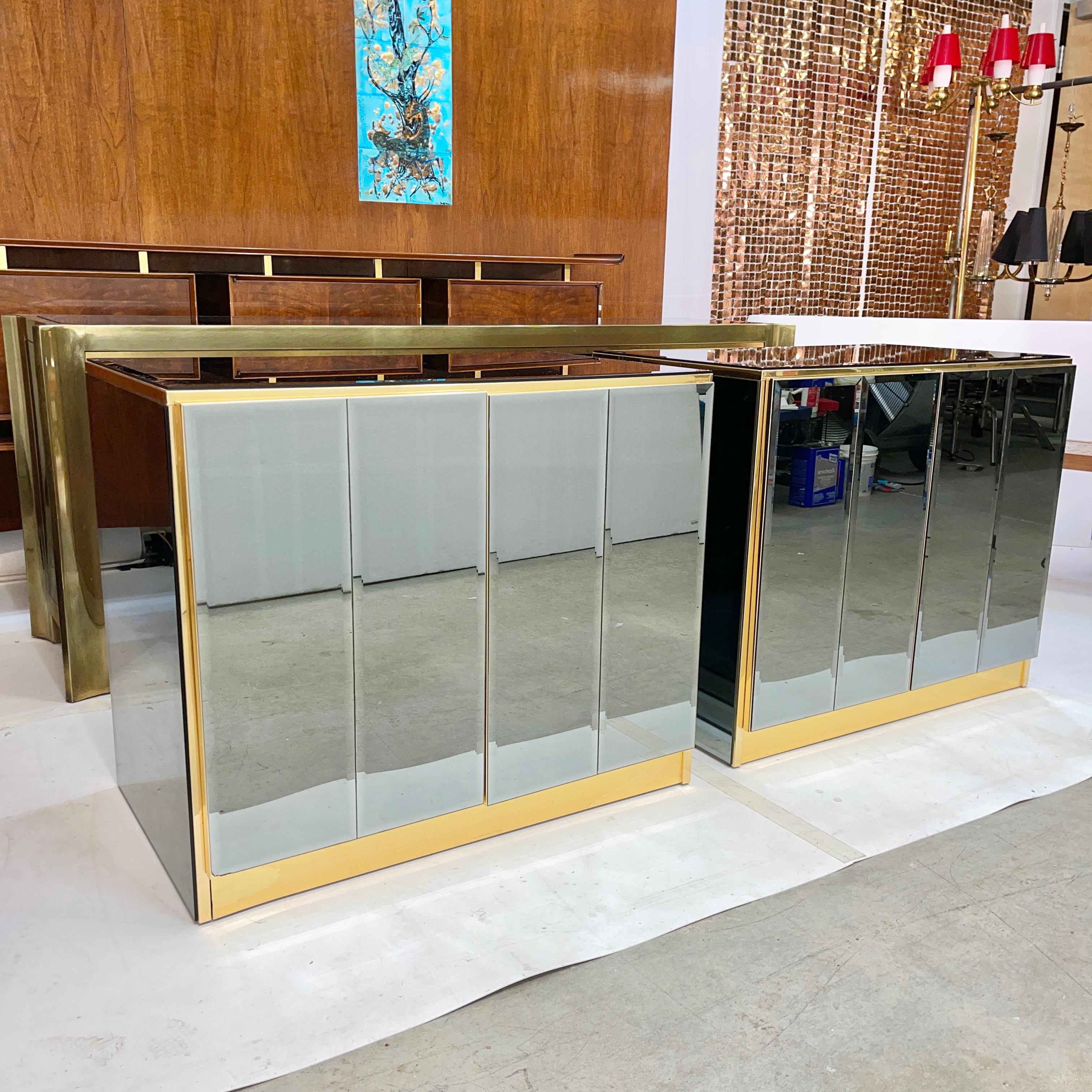 
Pair of mirrored cabinets or oversized nightstands by O.B. Solie for Ello Furniture Manufacturing Corp. clad on four sides in beveled blue/grey smoked mirror and trimmed in brass and brass anodized aluminum.
Both have double doors with magnetic