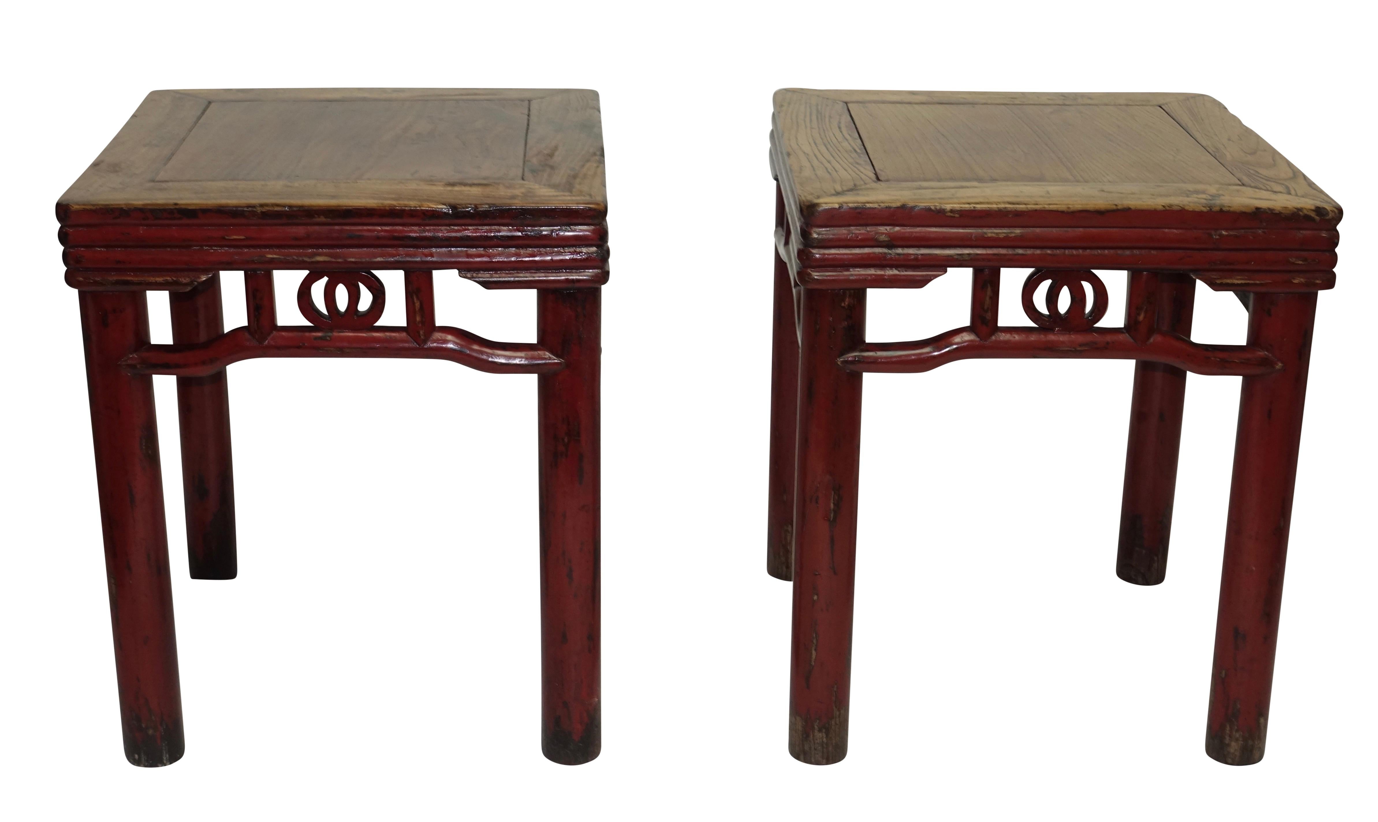 A pair of red lacquered elmwood stools or side tables with ribbed apron above concentric circular legs. China, Qing dynasty late 19th century.
