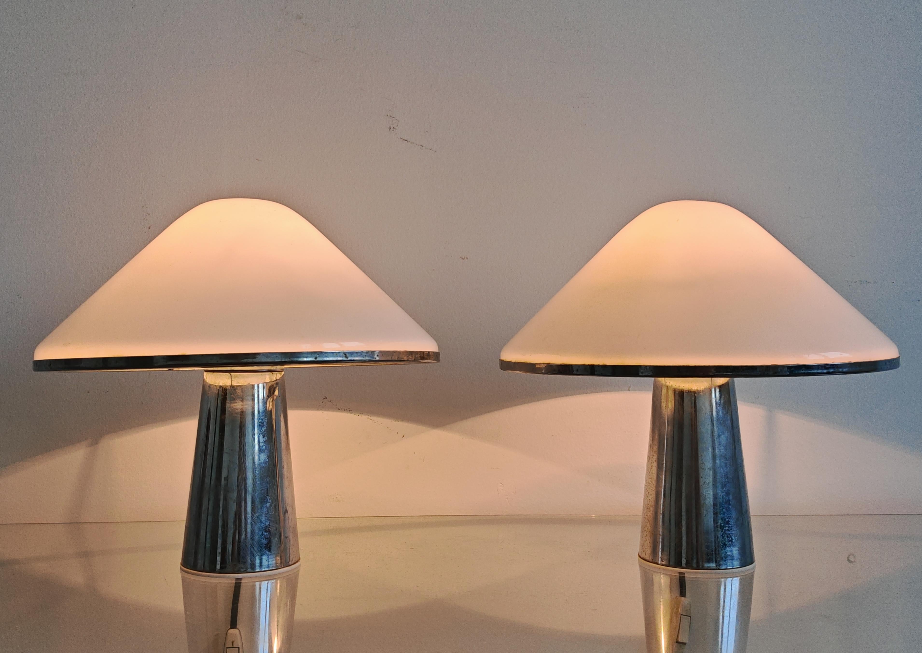 In this listing you will find a pair of exceptionally rare table lamps designed by Harvey Guzzini. This model is called 