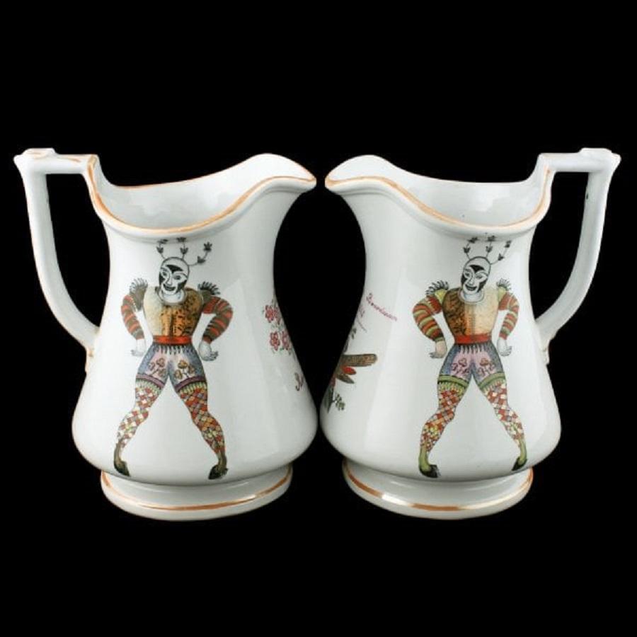 A pair of 19th century Victorian ironstone pottery puzzle jugs.

The jugs are decorated with very colourful Harlequin figures, one is marked Elizabeth Boardman 1863 and the other Richard Boardman 1863.

The jugs have the maker's marks for