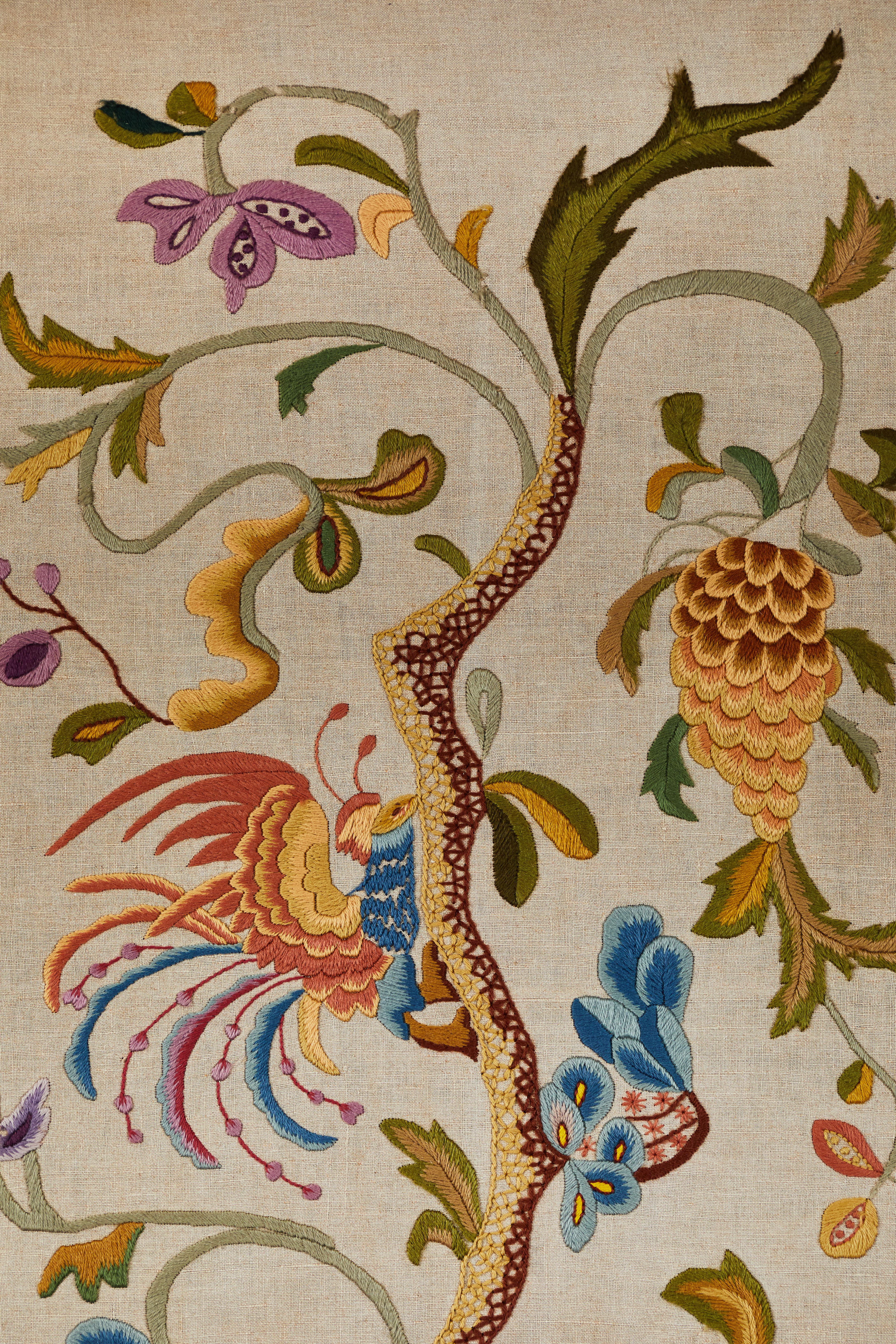 What a lovely pair Tree of Life textiles! With vining trees, birds, flowers, and grapes, this is a pair of fantastic circa 1920s antique homespun linen curtain panels with hand crewel needle work. Panels have been mounted to a frame and set in