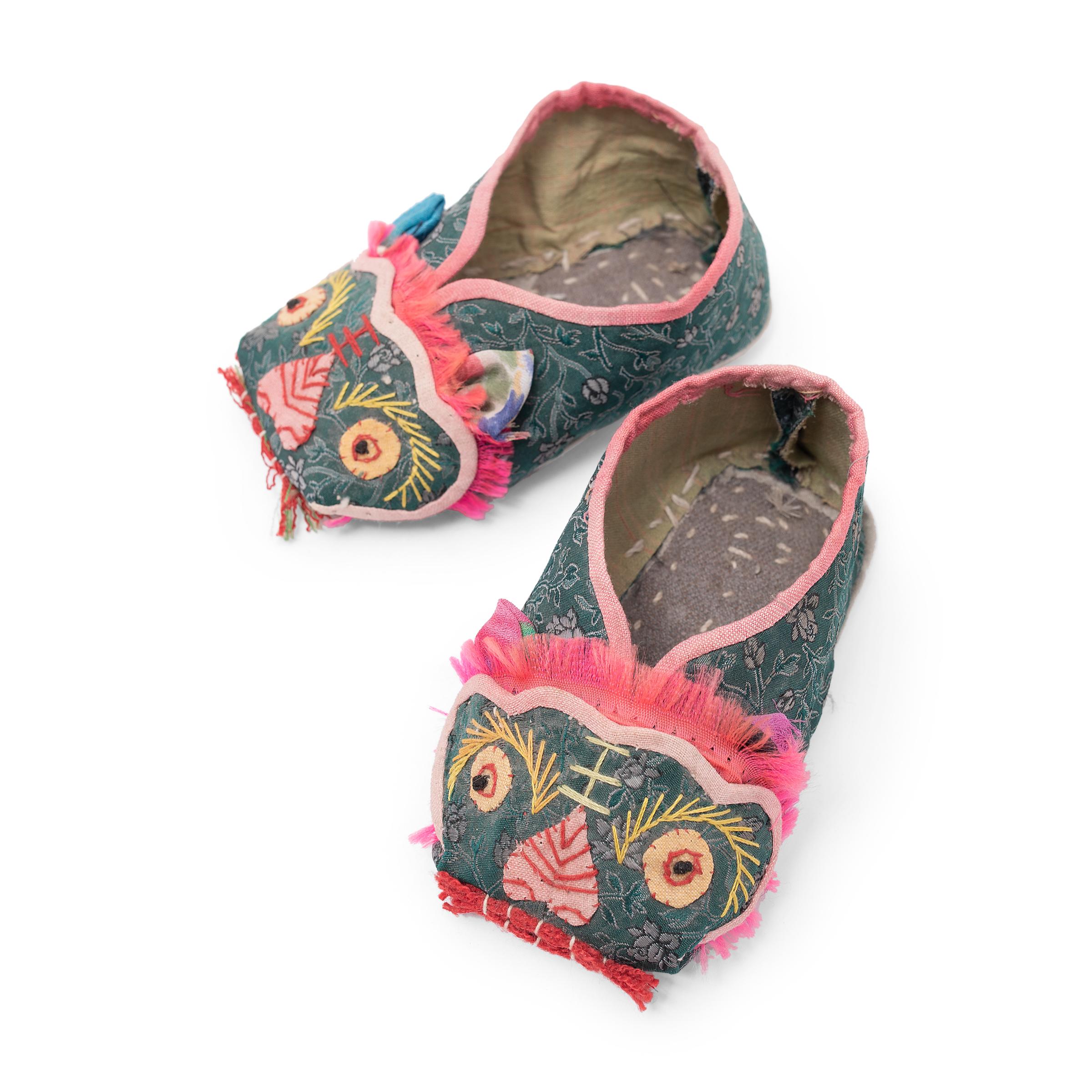This charming pair of petite children's shoes are lovingly hand-sewn of silk and cotton, embroidered to look like little lions. Powerful yet benevolent, the lion is considered the 