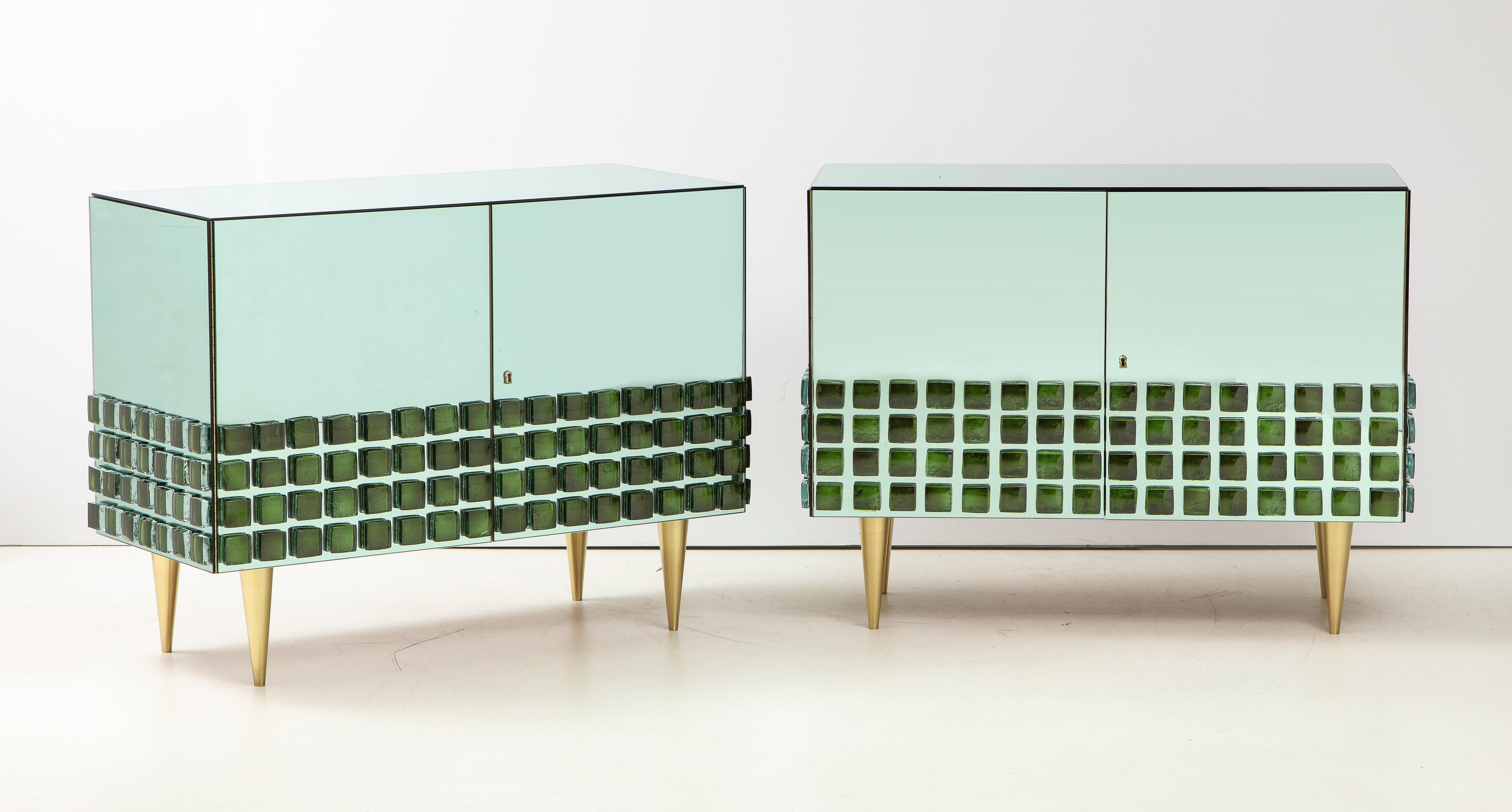 One of a kind pair of soft green tinted mirrored art glass with Emerald green murano glass blocks cabinets or nightstands handmade in Florence, Italy by a master artisan and artist. Solid wooden body in beechwood is veneered with a soft emerald