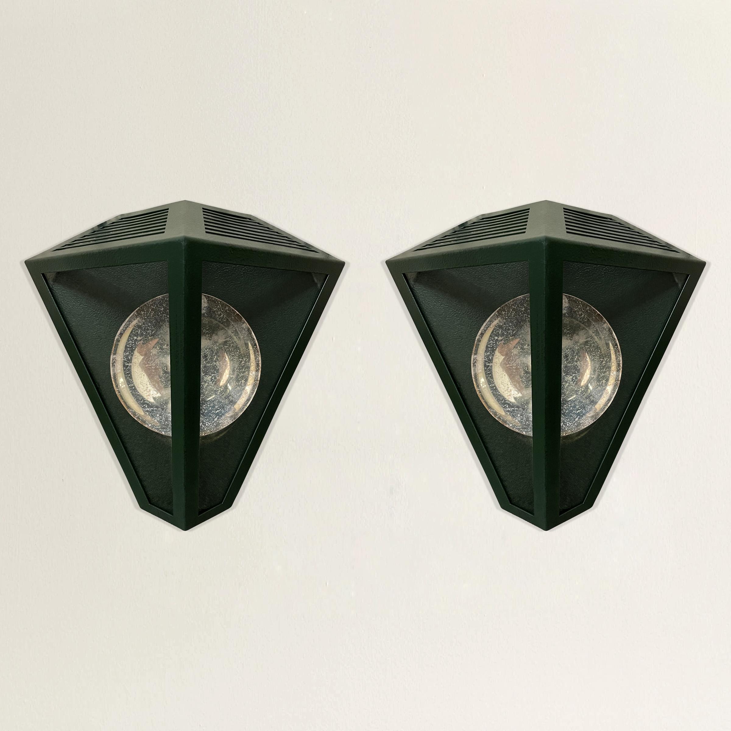 A striking pair of late 20th century American Rose Tarlow designed wall lanterns with a sophisticated emerald green painted finish, and silver-plated reflectors. Wired for US; candelabra bulbs.