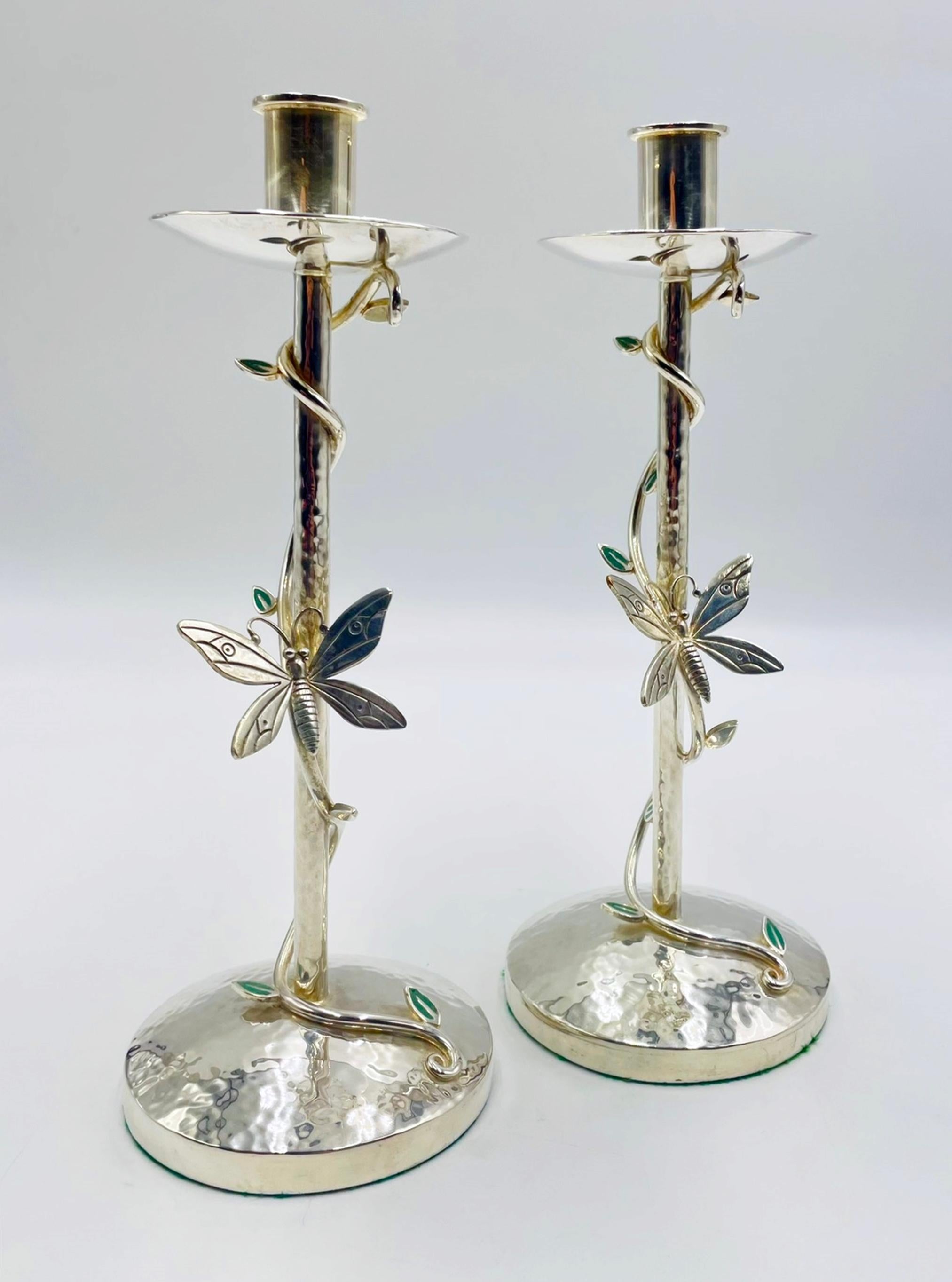 A charming and sculptural pair of silver-plated candle holders designed and handcrafted in Taxco, Mexico by acclaimed silversmith Emilia Castillo. These whimsical candlesticks feature a hammered base and a slender stem wrapped with a vine motif,