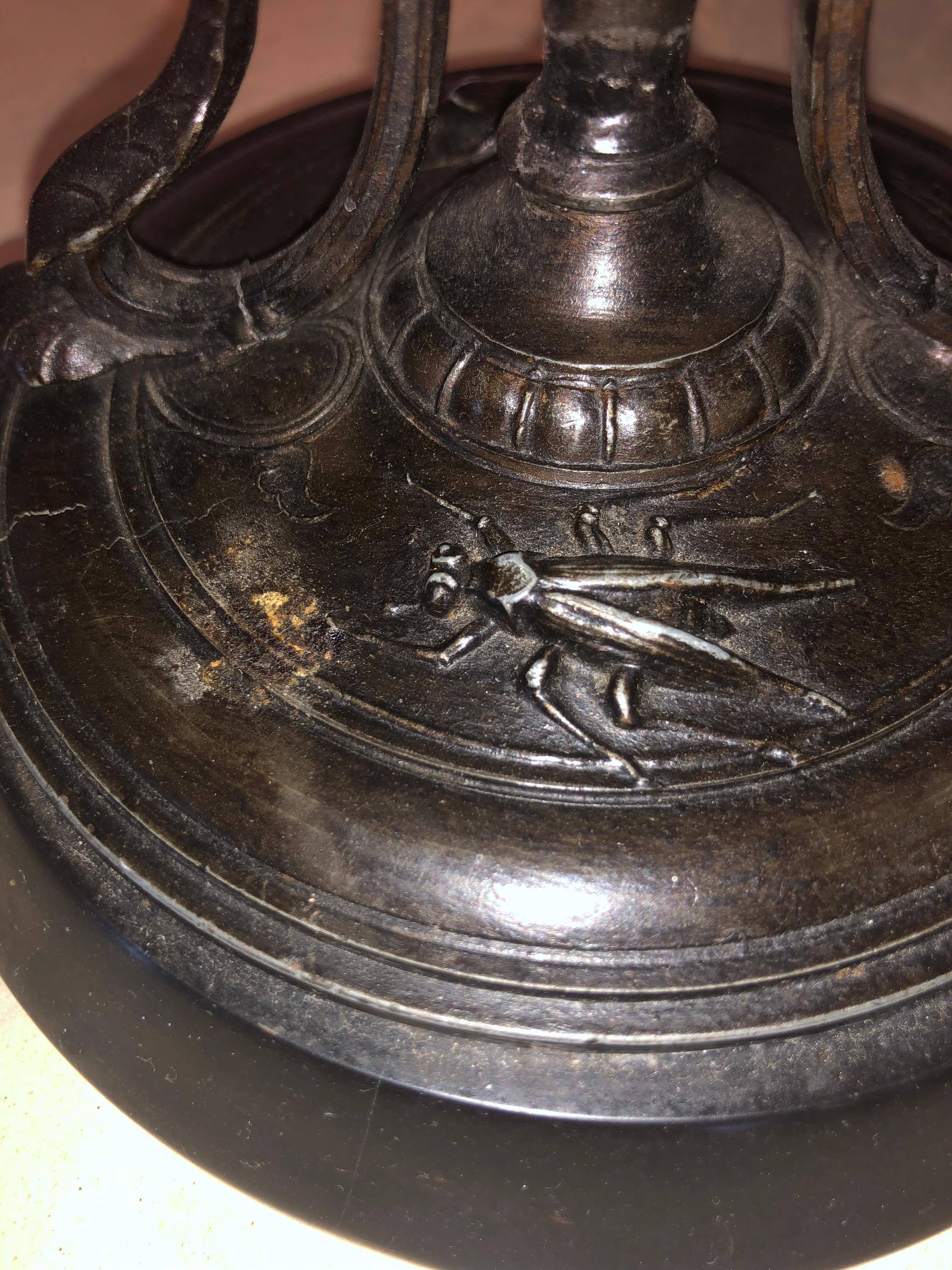Pair of Empire 19th century bronze candelabras depicting insects. These are quite possibly the finest cast bronze pieces on the market. Each having a center column formed rod with winged full bodied birds leading to a base with insects on the finely