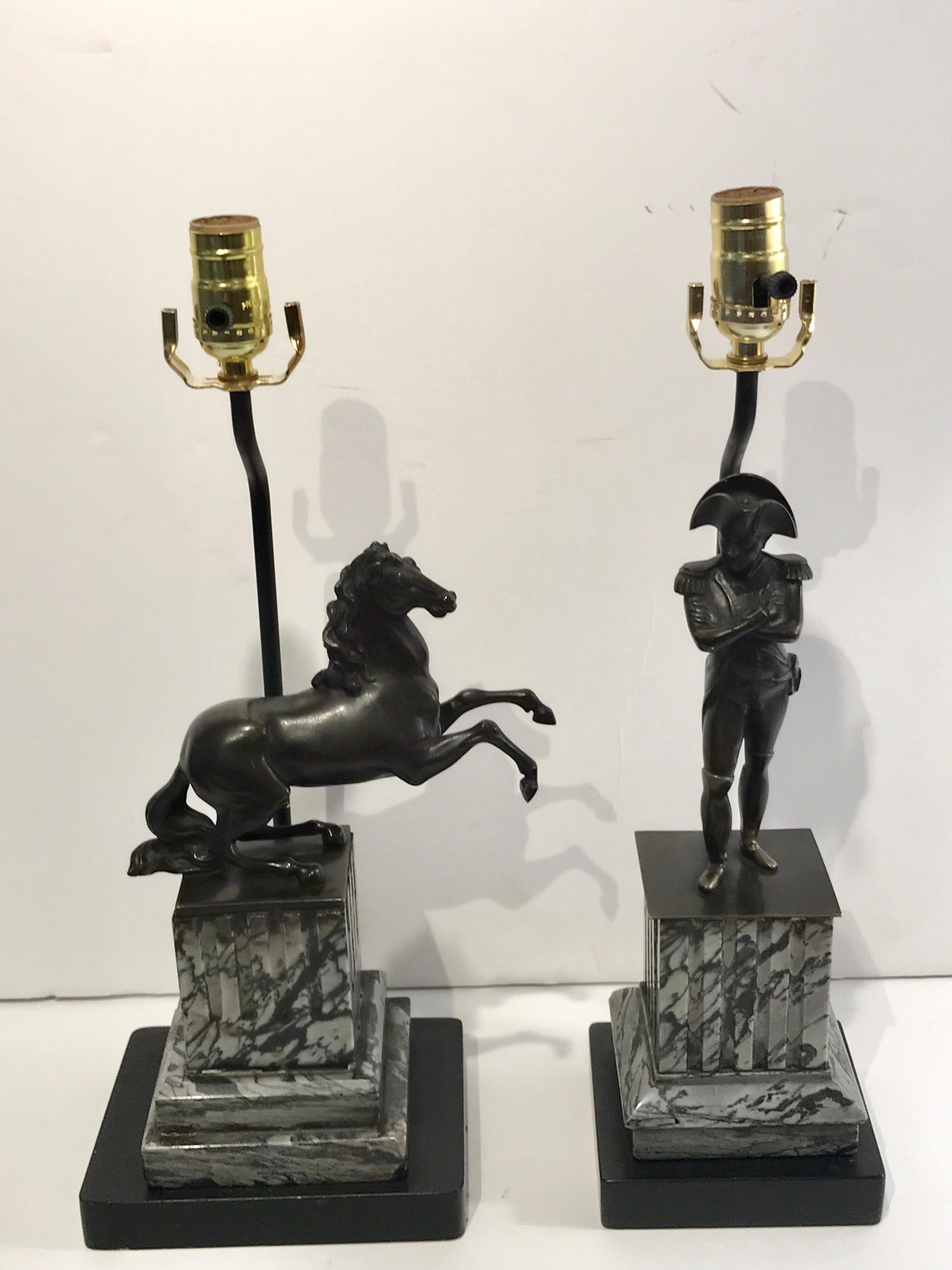 Pair of Empire bronzes, Napoleon & Marengo, now as lamps, one of a military dressed Napoleon with crossed arms the other a rearing model of his war horse Marengo. Both raised on carved black and gray marble plinth bases
Napoleon: 5.5