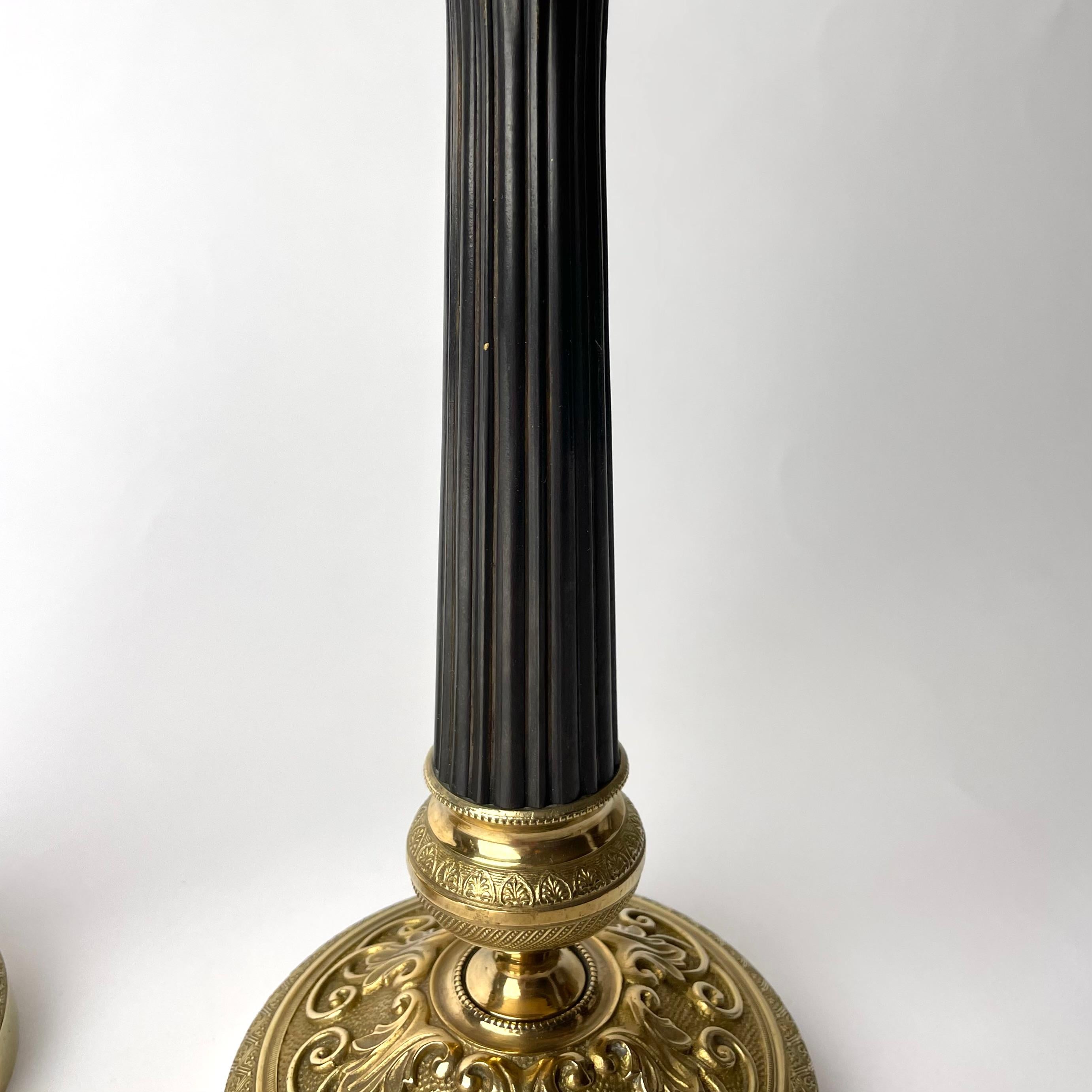 Early 19th Century Pair of Empire Candlesticks in gilded and darkpatinated bronze from the 1820s For Sale