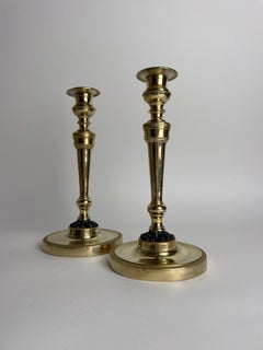Pair of Empire Candlesticks in gilt bronze with dark patinated Lion paws. 1810s