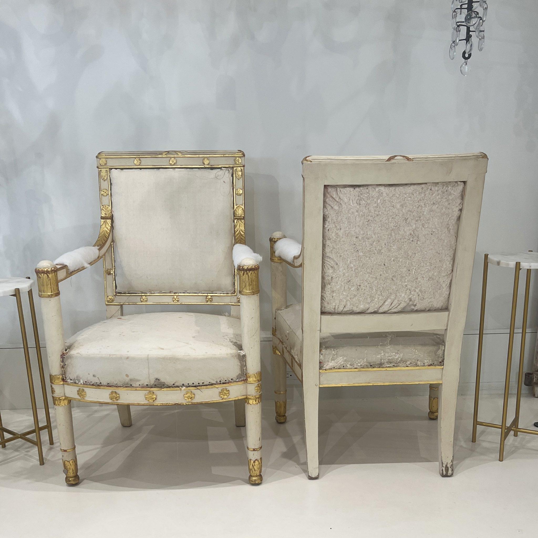 Matching pair of Empire armchairs attributed to Henri Jacob. Seats and backs are covered in muslin. Painted off white with gold detailing. Very stable construction.