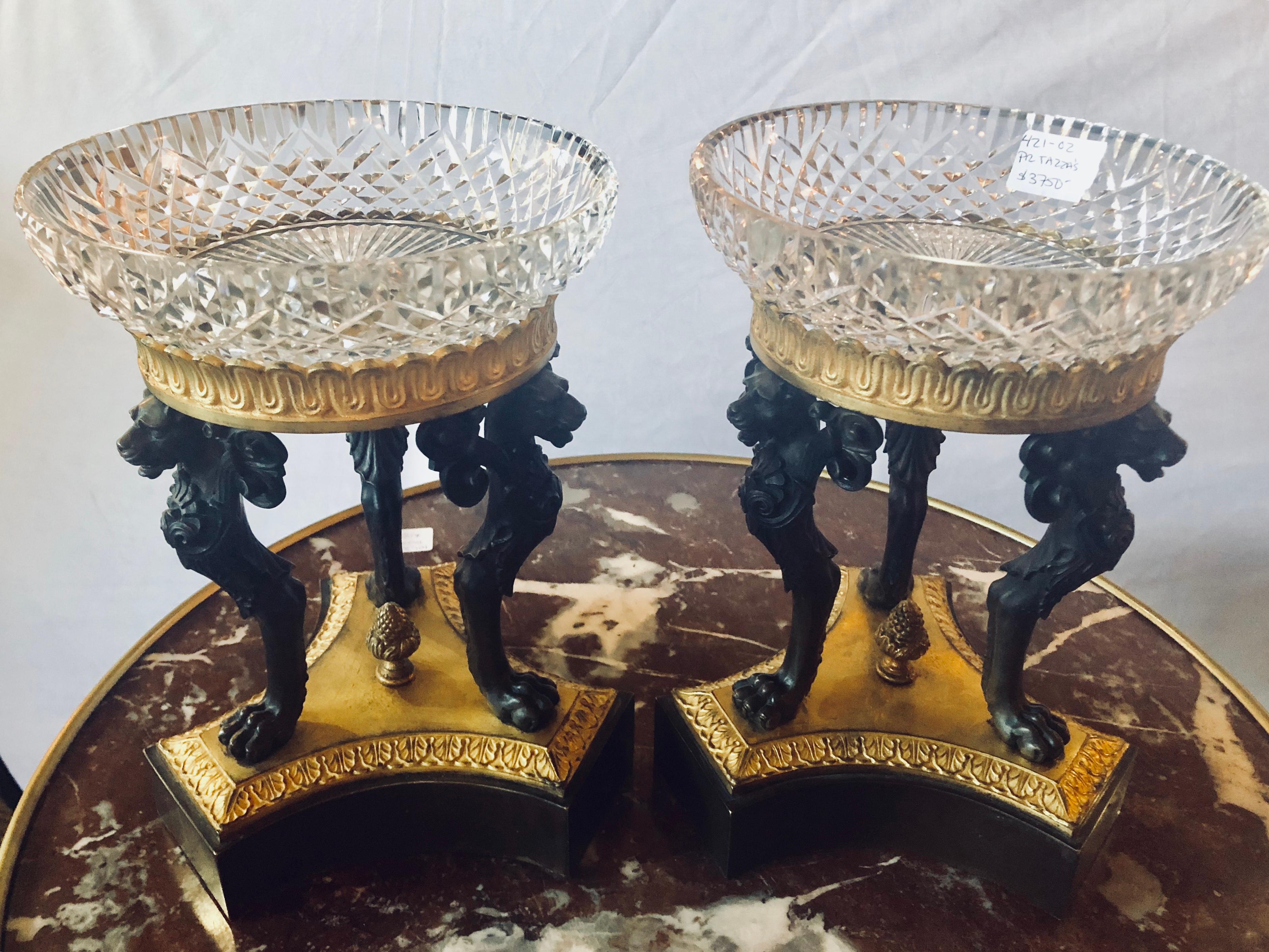Pair 19th century Empire Figural Tazzas / Compotes doré and patinated with Cavan signed crystal bowls. This simply stunning pair of Tazzas have crystal compotes signed Cavan supported by a doré bronze apron having three full bodied winged lions on a