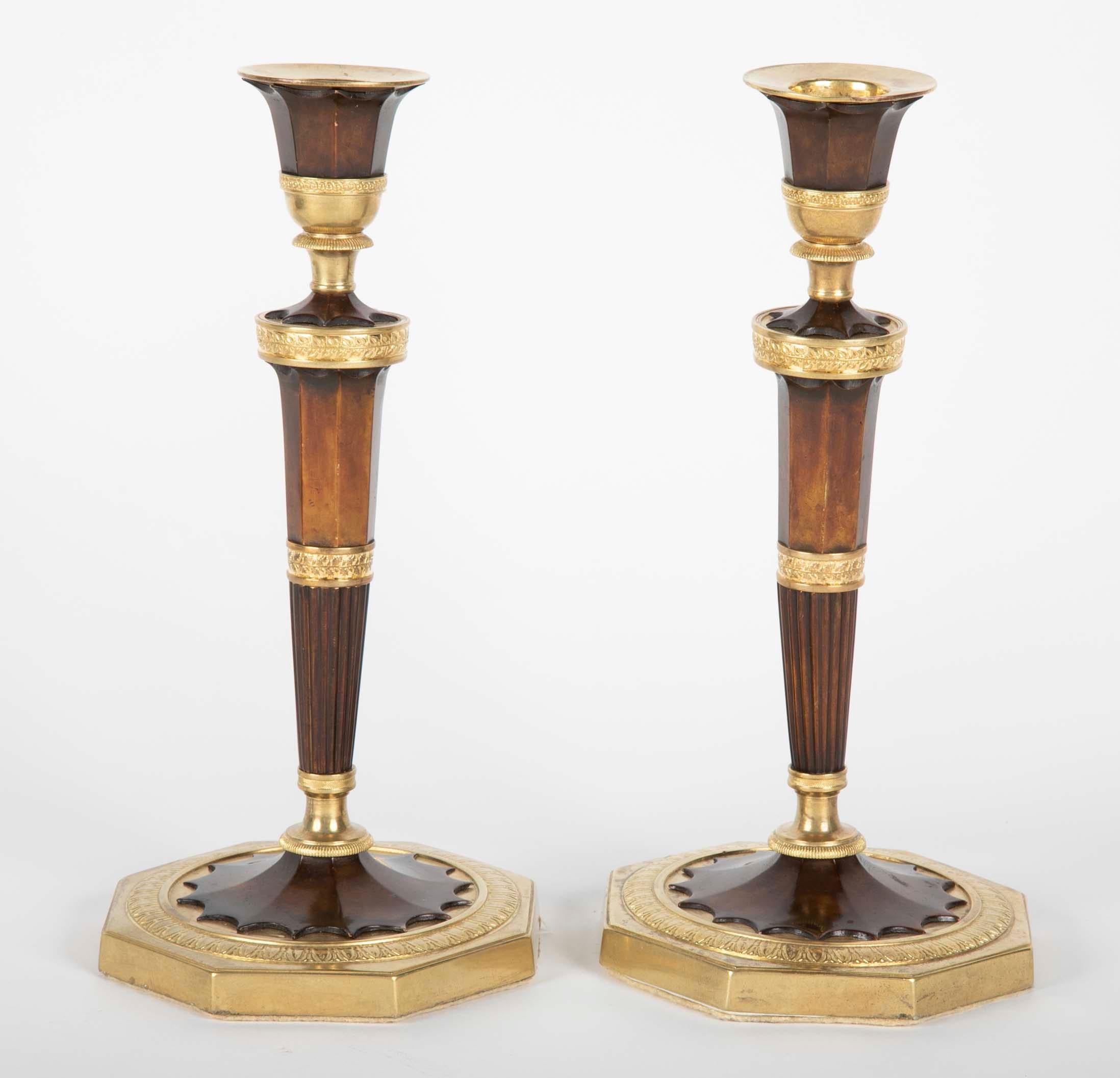 A pair of French gilt bronze candlesticks.