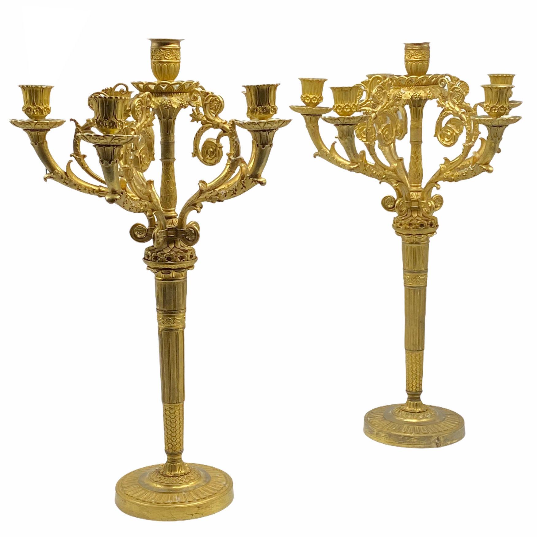 Pair of period Empire French early 19 century gilt bronze candelabras.