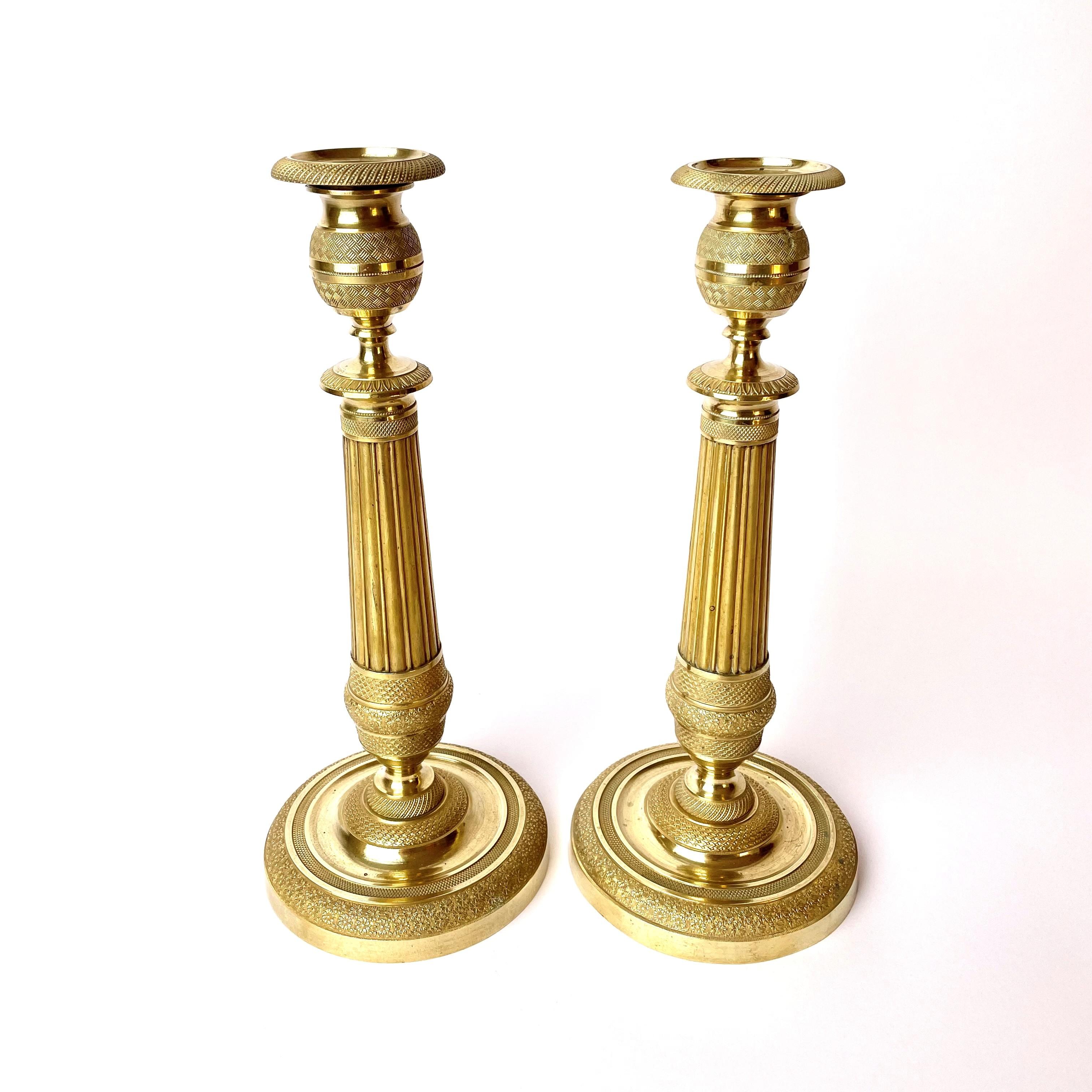 Wonderful pair of Empire gilt bronze candlesticks from the early 19th century, made in France. Very nice original finish with light ware consistent with age and use.