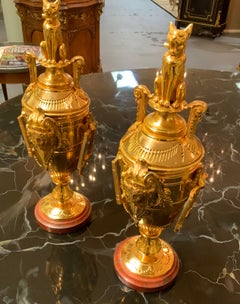 Pair of empire gilt bronze garniture on rouge marble base