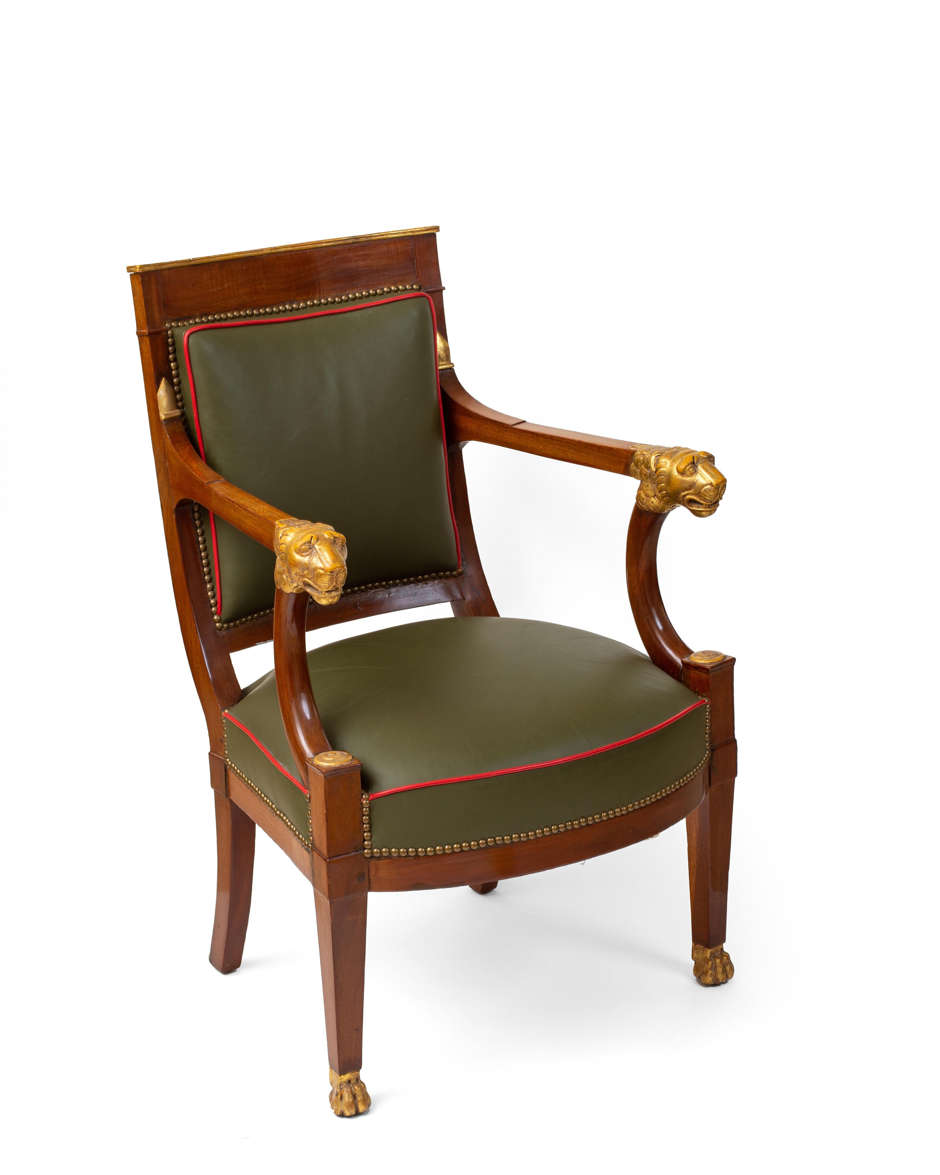 Each curved crestrail above a square padded back and seat, the arms terminating in lion heads, raised on tapering square legs ending in lion paw feet. Upholstered in two-tone leather.
The elegantly curved arm supports, the beautiful carving and the