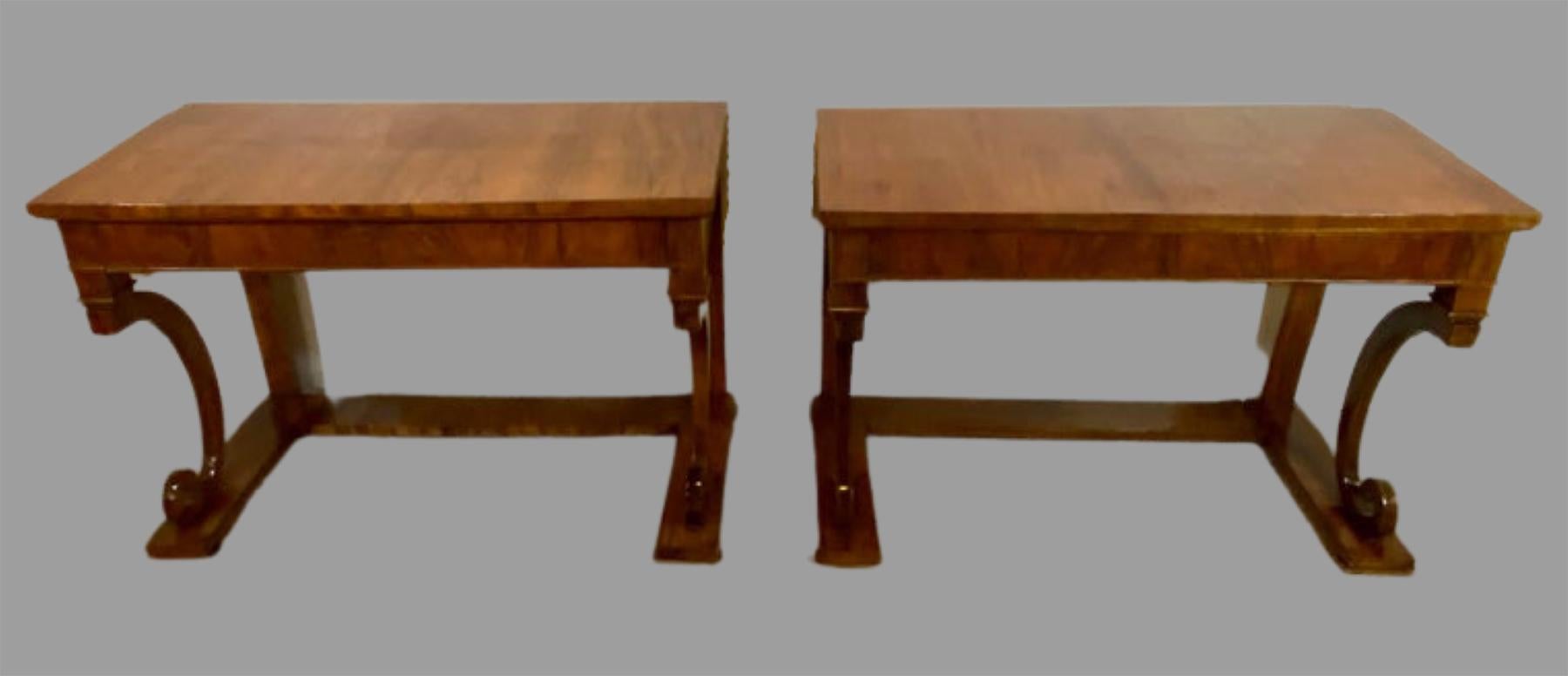Pair of Empire Period rosewood consoles or pier tables each dating back to the late 18th century. The pair with deep C scroll column support sides sitting on a flat base leading to a single large drawer under a finely patinated table top. The pair