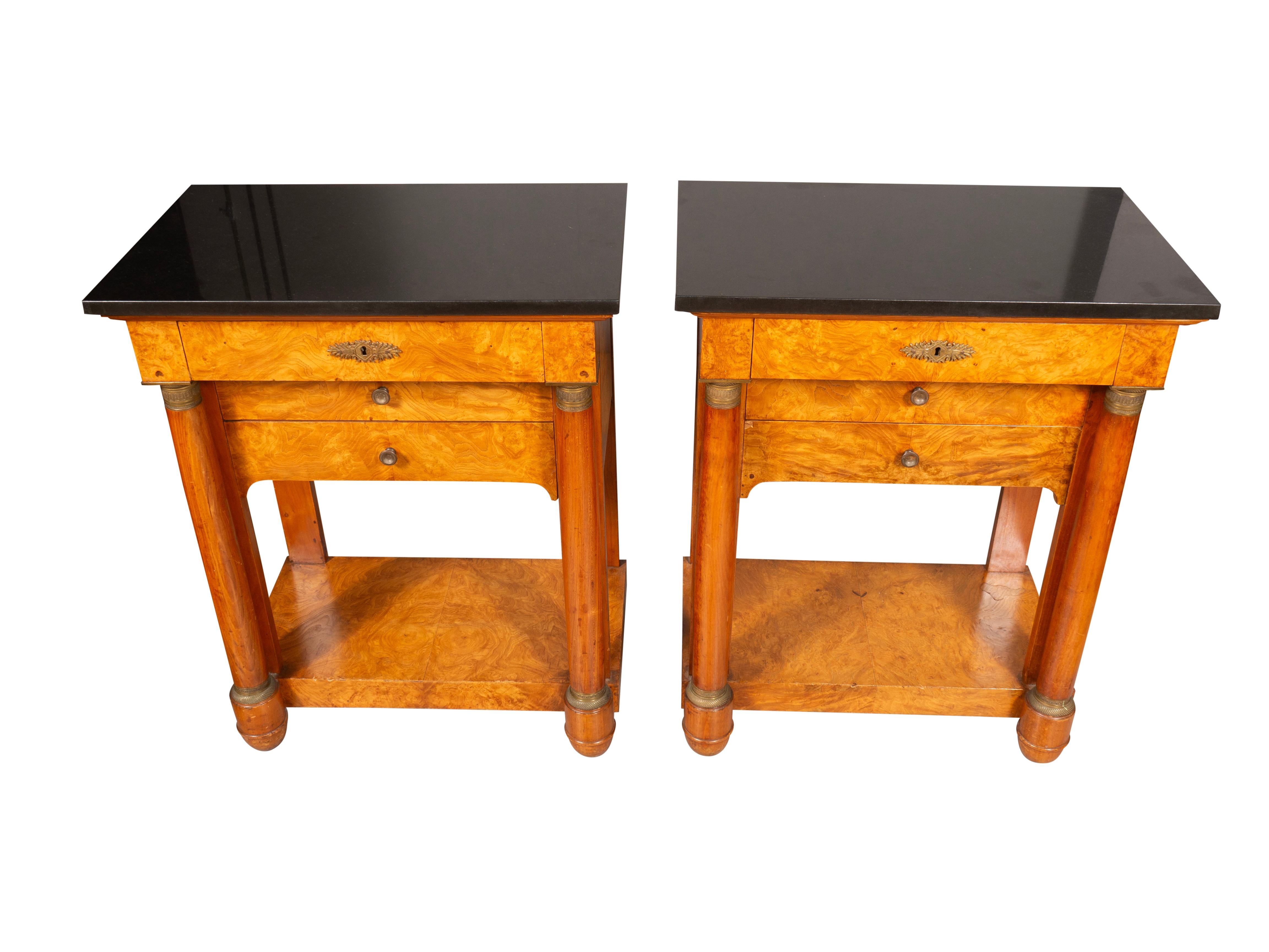 Each with rectangular black granite tops over three drawers flanked by columns and lower shelf. 