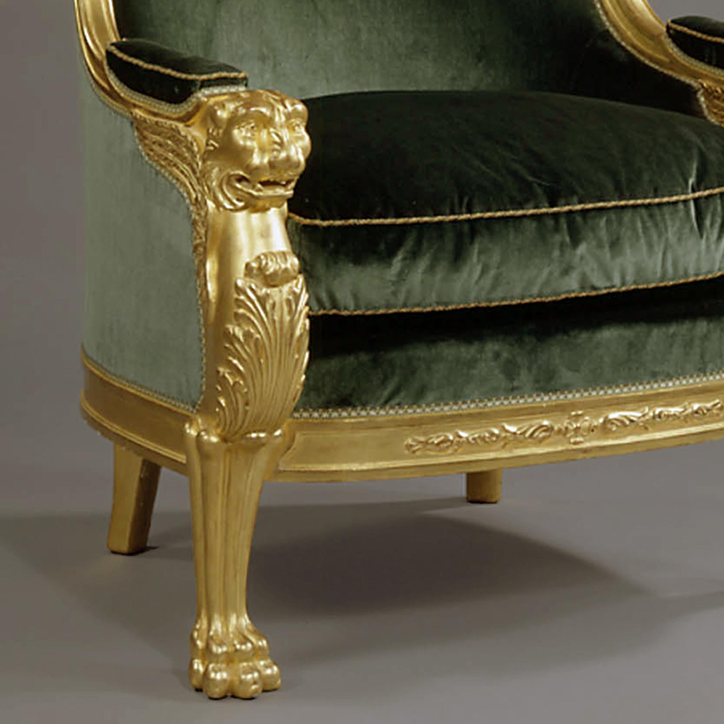 An Important Pair of Empire Style Carved Giltwood Tub Chairs with Green Velvet Upholstery.  The Lion Monopedia side supports feature finely carved detail and a realistic pose.

These extremely large chairs are unusual because of both their size and