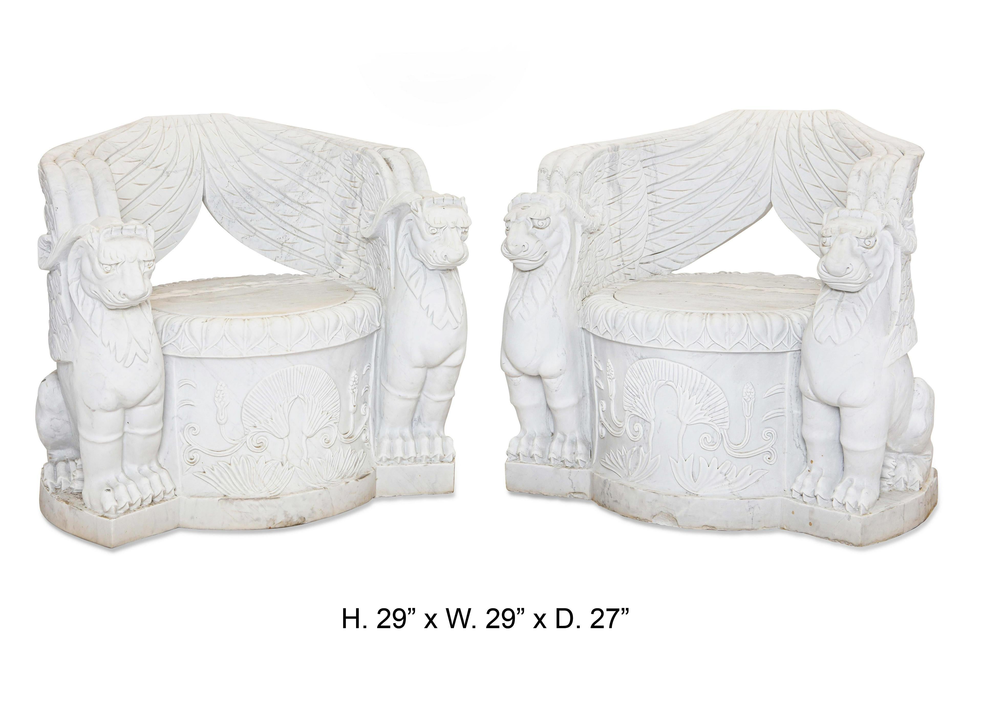 Impressive pair of Empire style carved white marble chairs.
The beautifully hand carved white marble chair decorated with a foliage motif is flanked by two large seated winged griffins under each arm,
20th century.
Each chair is carved from a