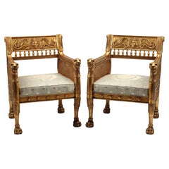 Paar geschnitzte und vergoldete Sessel im Empire-Stil