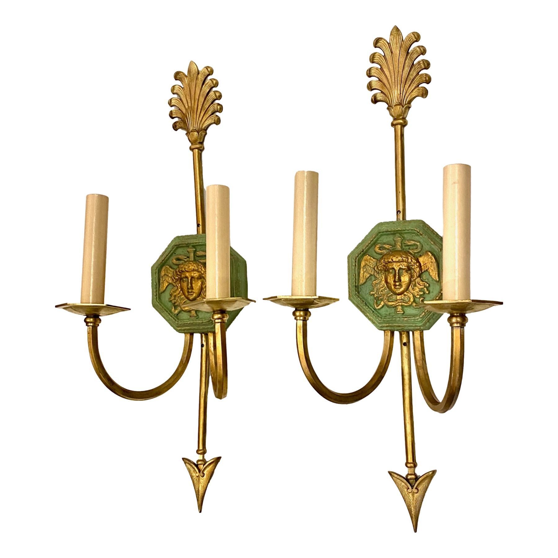 A pair of circa 1920's French painted and gilt sconces with neoclassic design and gilt bronze body.

Measurements:
Height: 20