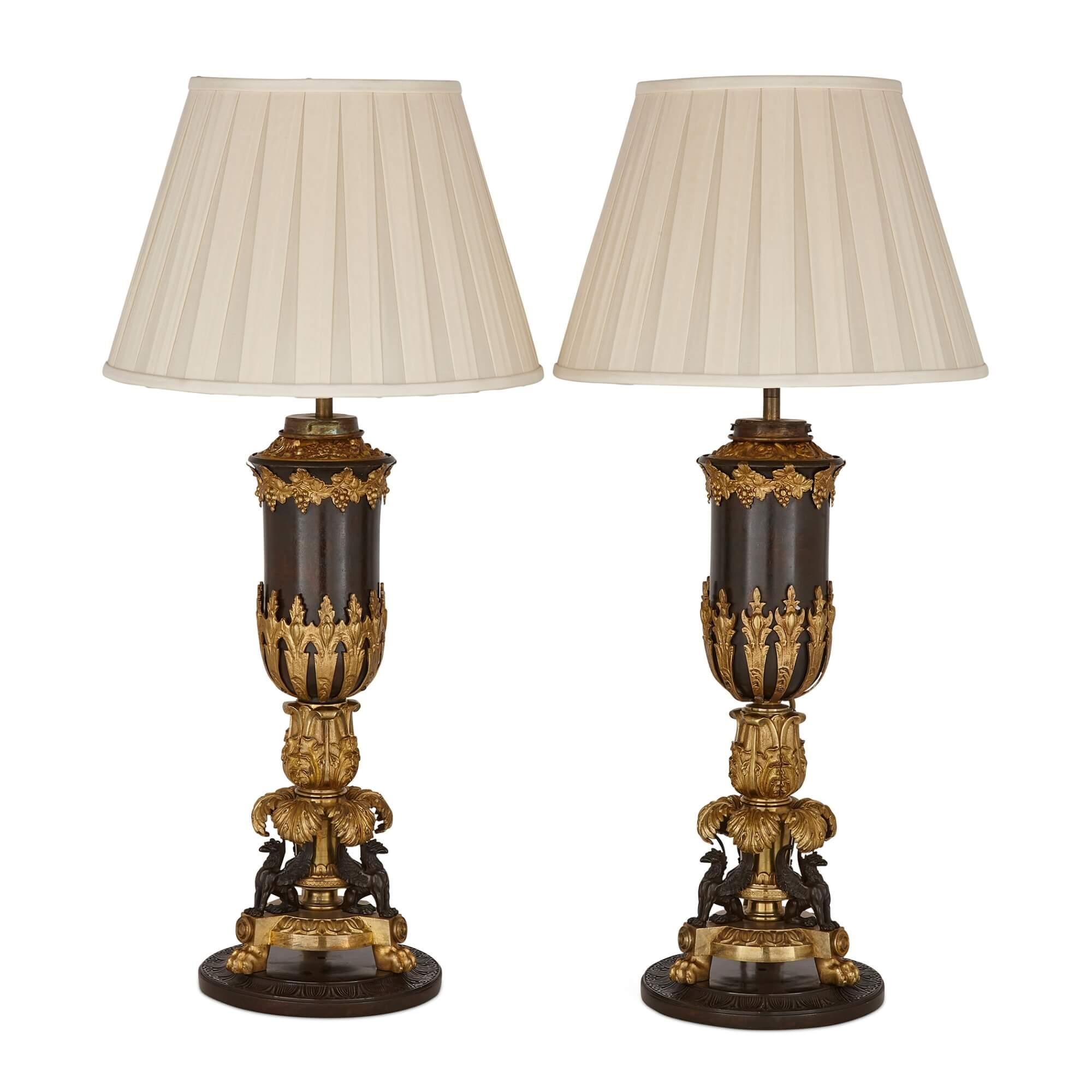 Pair of ormolu and patinated bronze Empire style table lamps
English, Late 19th Century
Lamps: height 56cm, diameter 20cm
Shades: height 24.5cm, diameter 35cm

Crafted during the late 19th century, these fine and delicate antique table lamps are