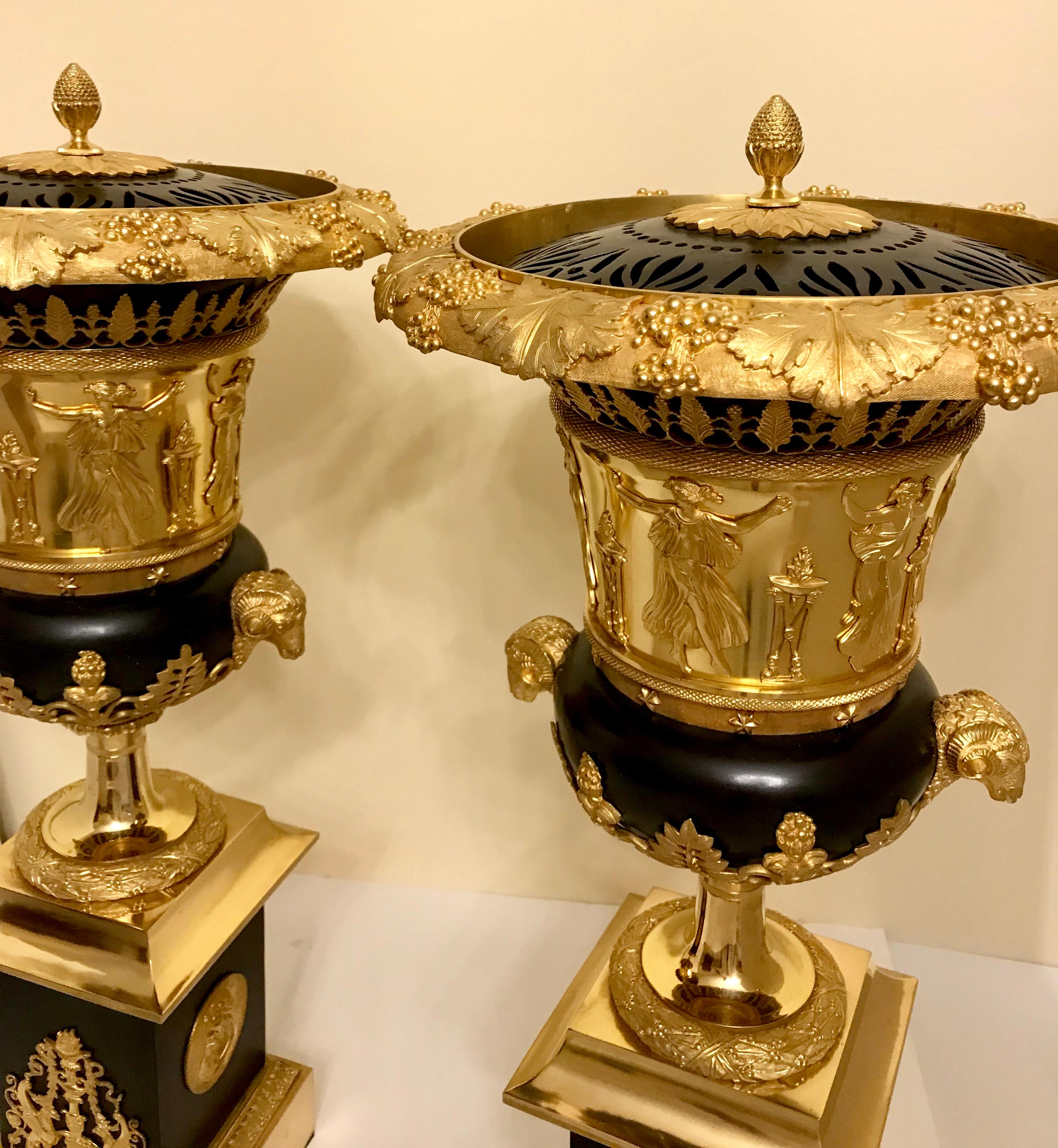 A pair of Empire style gilt bronze Brule-Parfums in manner of Pierre-Philippe Thomire, 19th century
each openwork cover with an acorn finial above the body having a rim cast to show grape bunches and a continuous band of classically draped figures,