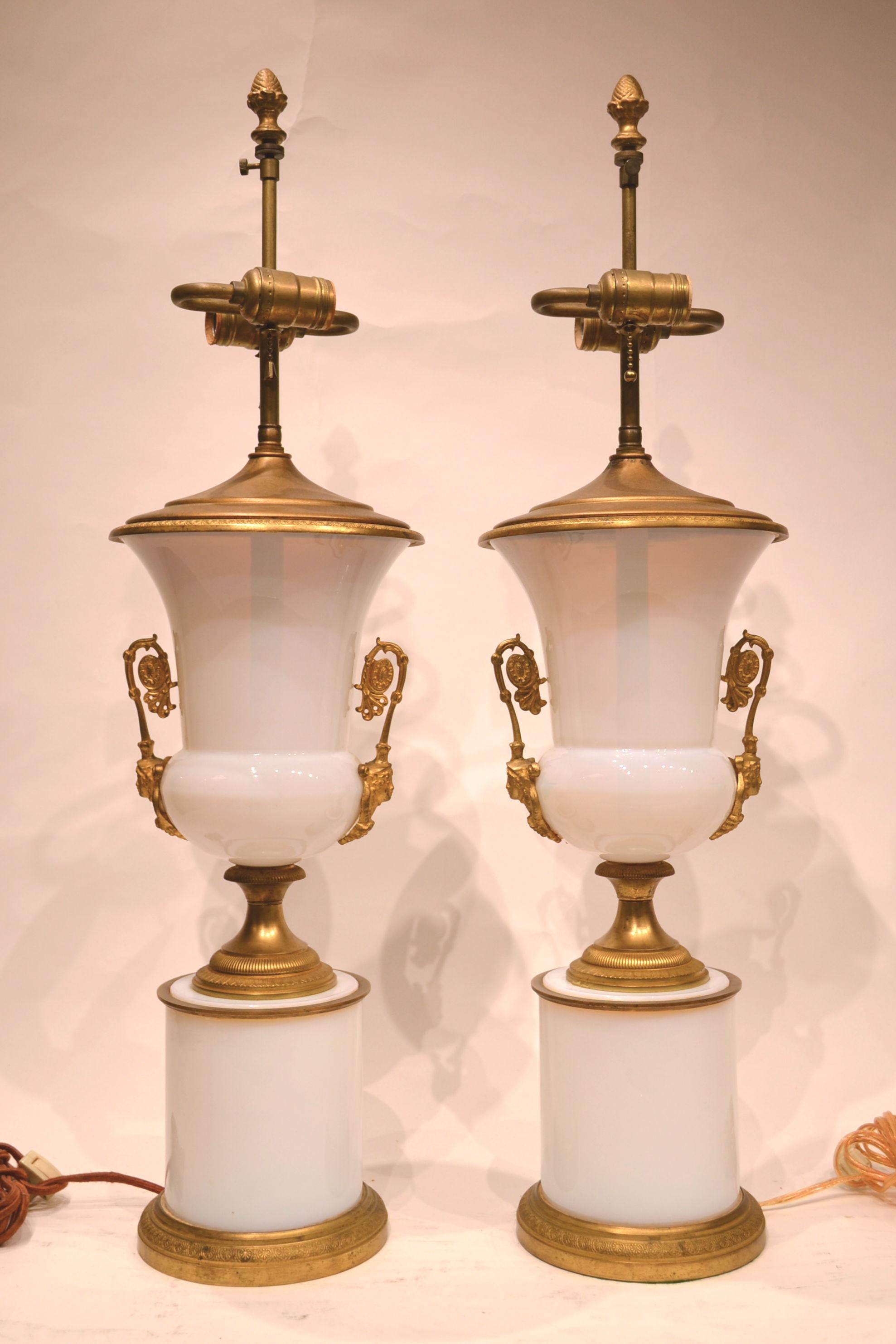 Pair of French Empire style gilt bronze mounted white opaline glass table lamps.