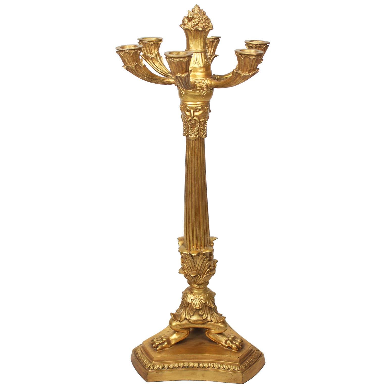 A Tall Pair of Empire Revival Style Gilt-Metal Six-Light Candelabra, after a model by Pierre-Philippe Thomire (1751–1843). Each gilt-leaf finished candelabra with a fluted center stem crowned with six-scrolled candle-arms and centered with a floral