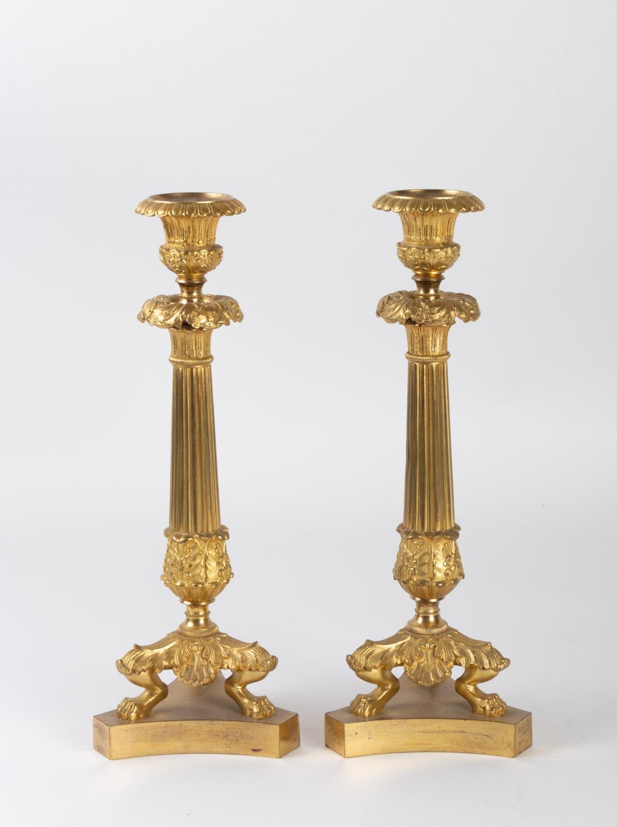 Pair of Empire style gilt bronze candleholders with their bobèches, 19th century

Measures: H 32cm, D 12cm.