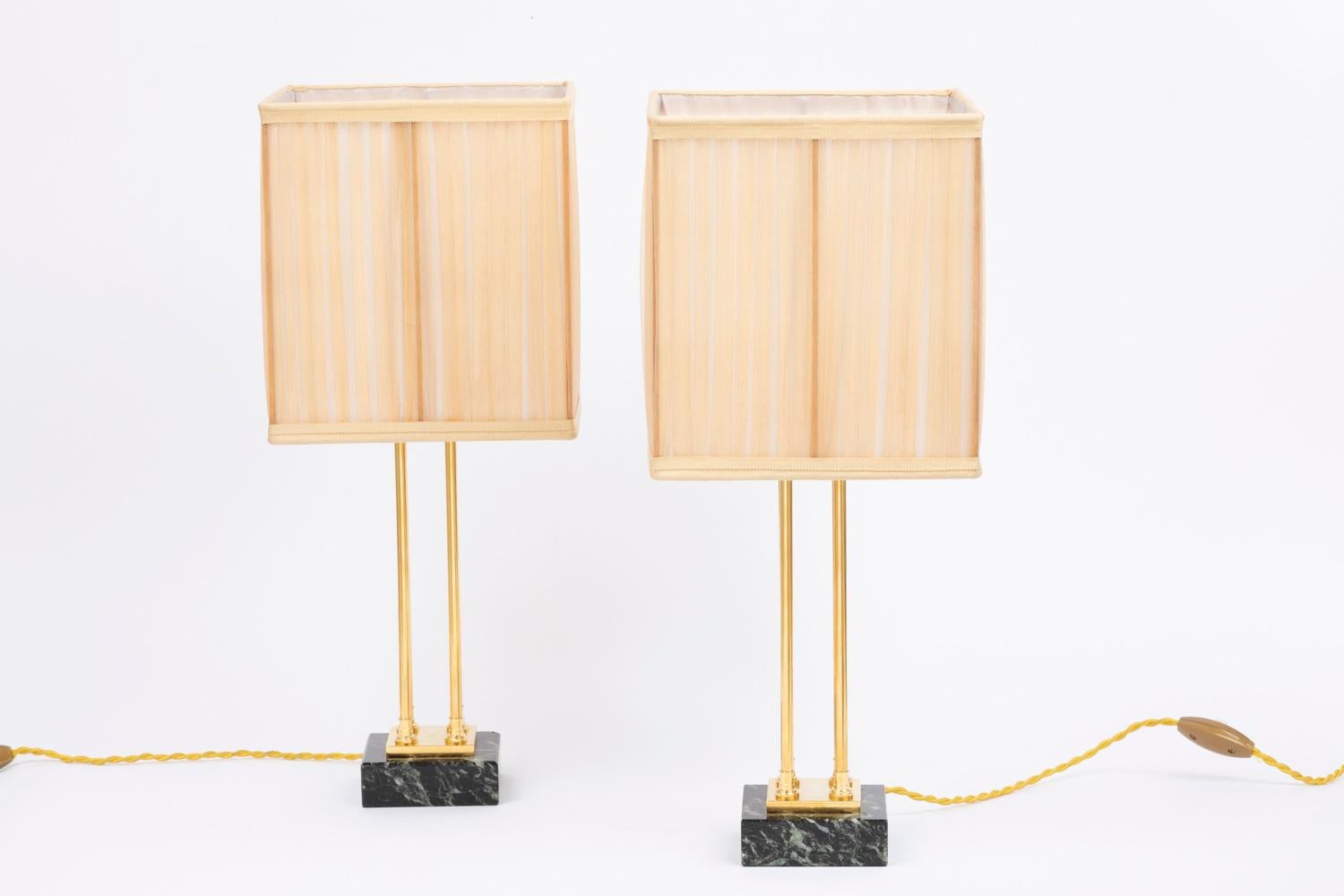 Pair of Empire style lamps in gilt bronze and marble. Shaft composed of four small columns configured in square, topped by a square plate and a small ball.
Square shape base in sea green marble topped by a smaller gilt bronze plate.

Work realized