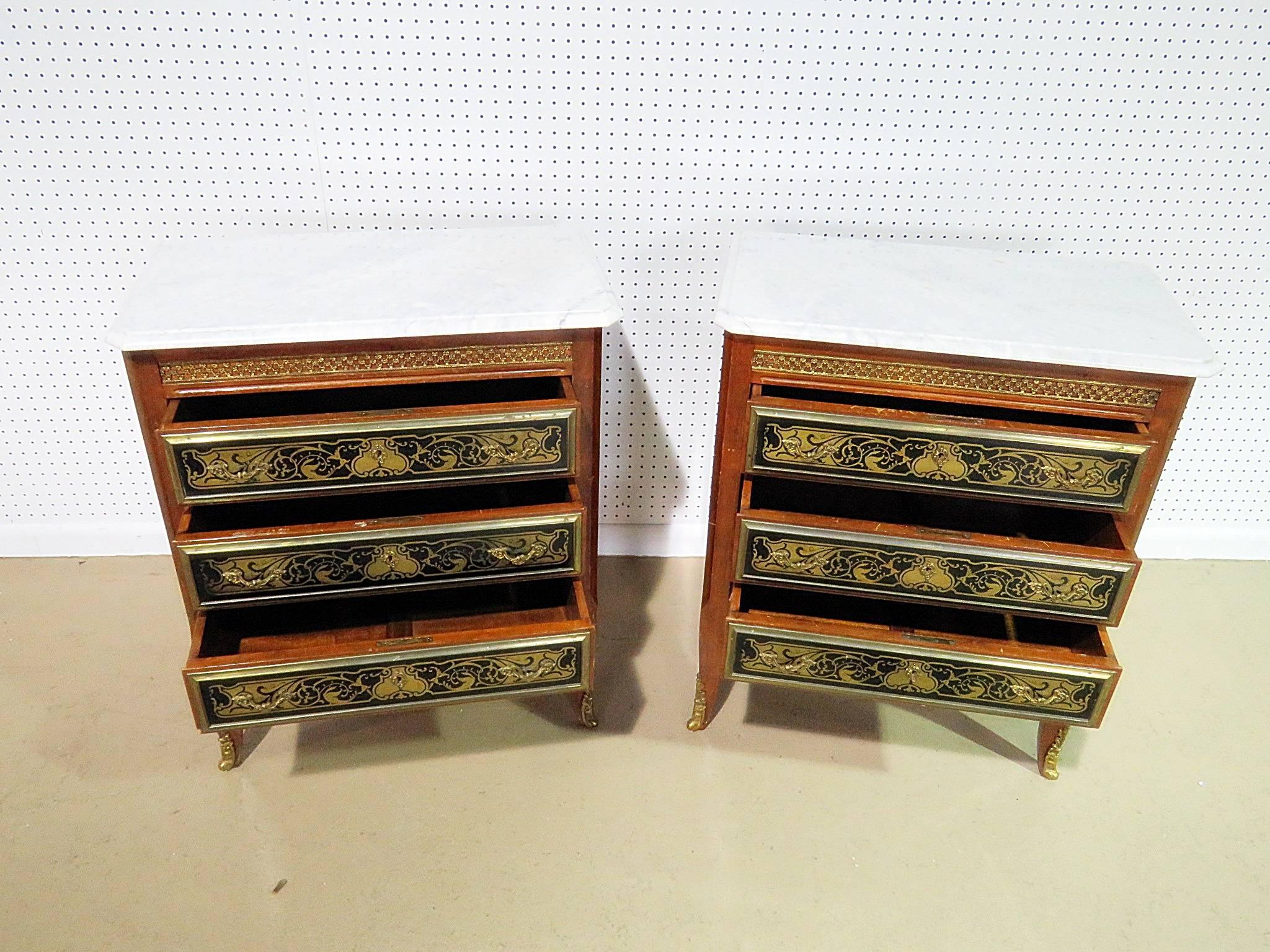 Pair of Empire style marble top three-drawer ebonized commodes with bronze mounts.