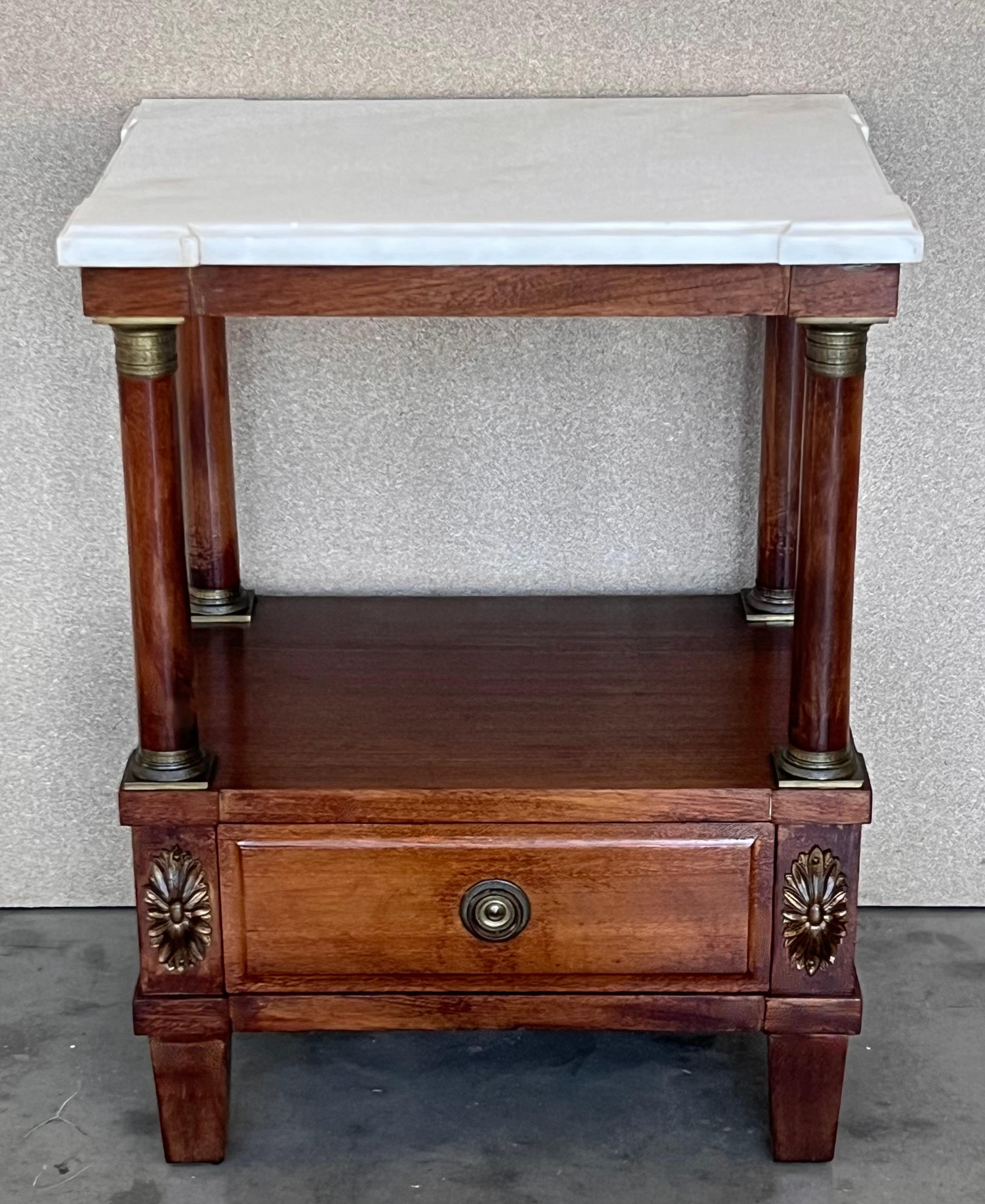 French Empire Solid walnut wood. Gilded and chiselled fittings. Two-wise frame base with protruding rectangular marble slab on square columns, joined by an intermediate compartment ending in rollers. Plate with beveled corners.