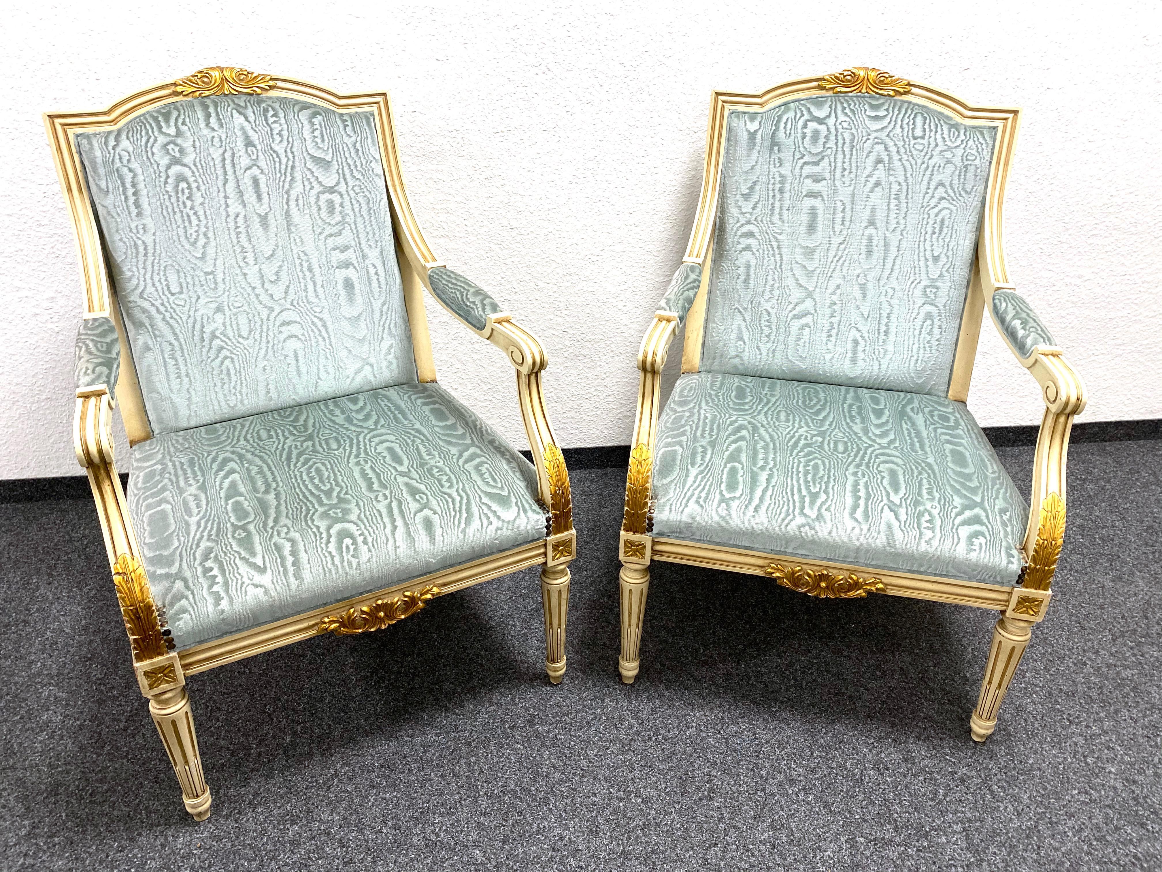 A gorgeous pair or crème or chippy white paint chairs in an Empire Style. These chairs have beautiful guilt details throughout. Add an elegant touch to your home with this exceptional pair of vintage chairs. Again, the chairs are in original as