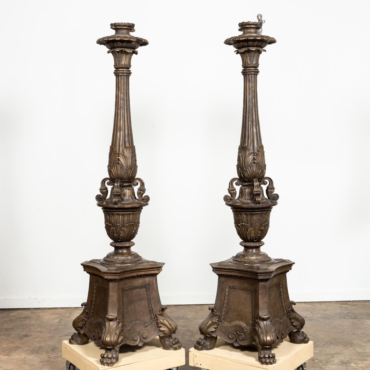 Pair of Empire style palatial composite torchieres with fluted column over acanthus leaf and urn form details, and rising on paw feet. Continental, second half 20th century. 
Dimensions: Height 83