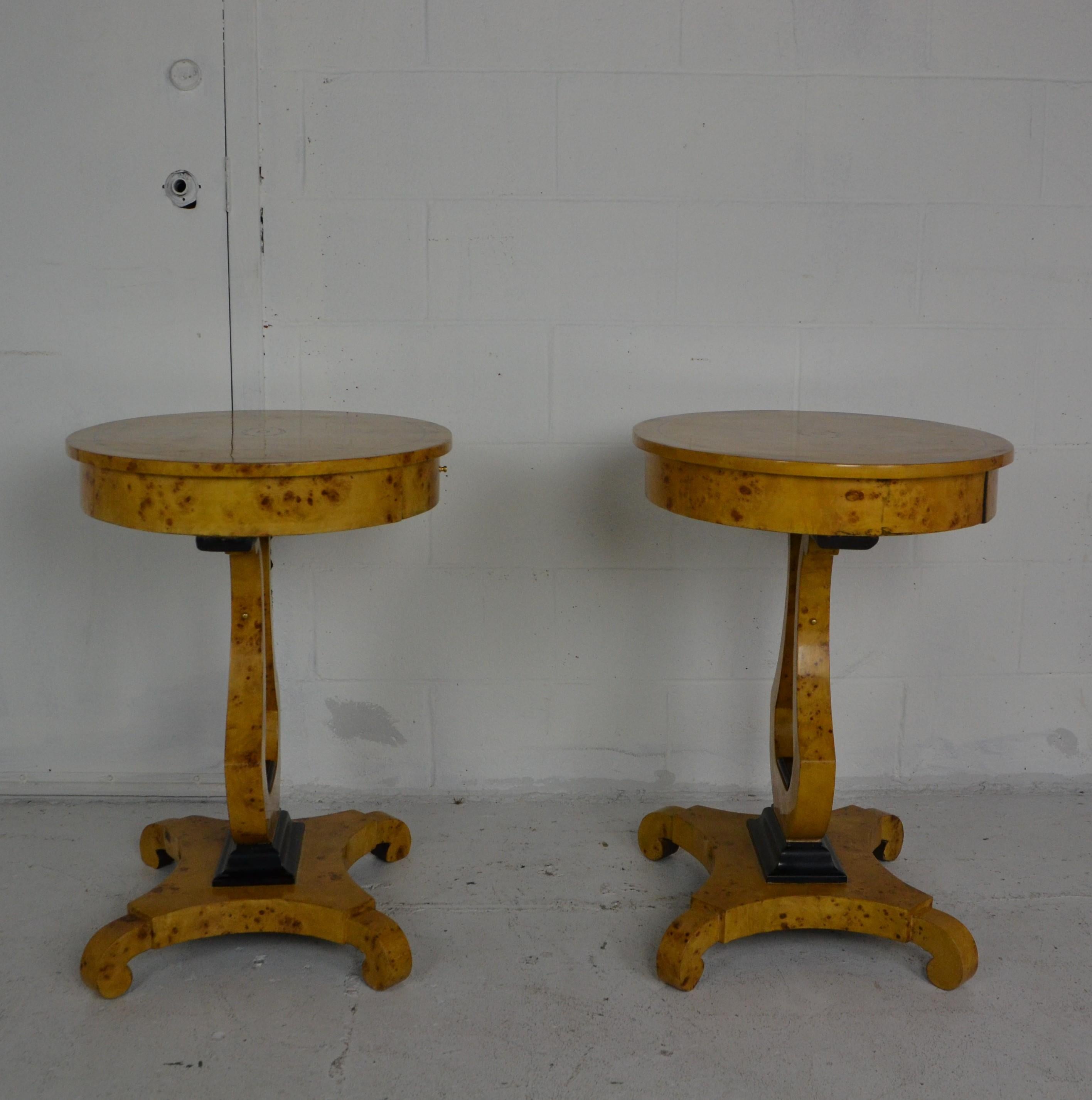 A pair of Empire style side tables or nightstands in bird's-eye maple. Each has a drawer over a Lyre style pedestal on a platform base.