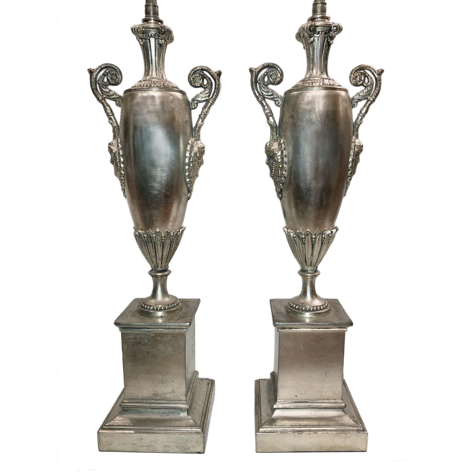 Pair of circa 1920s French silver plated Empire style urn-shaped table lamps with masks depicted on sides.

Measurements:
Height of body 20.5