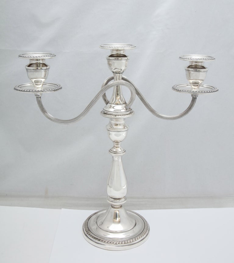 Pair of sterling silver, Empire style candelabra with removable branches, The Mueck-Cary Co., Inc., New York, circa 1930s-1940s. Each measures 13 inches high x 4 3/4 inches diameter across the base. x 13 inches across from end of candle cup to end