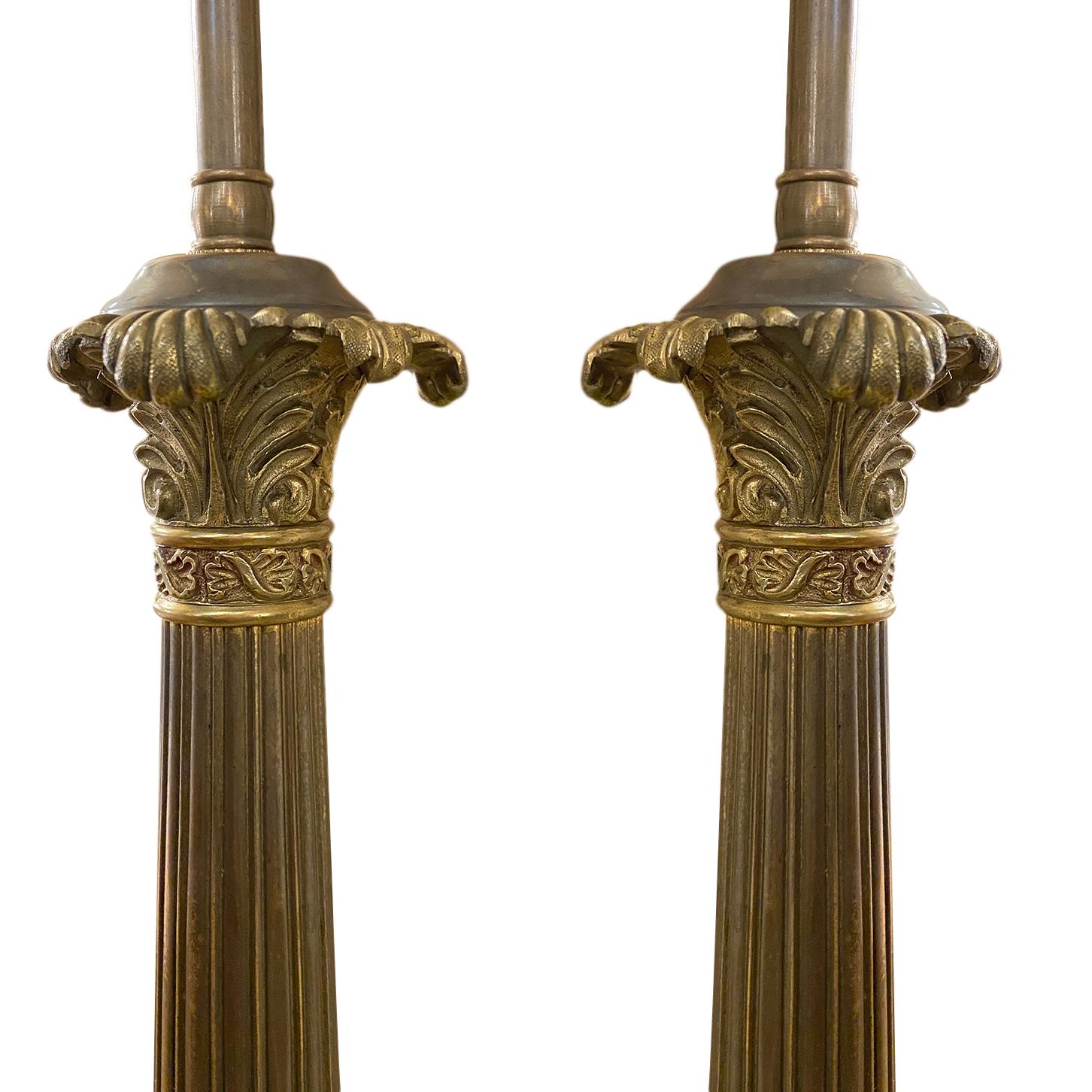 A pair of circa 1900s French Empire style bronze column candlestick table lamps with original patina.

Measurements:
Height of body 18